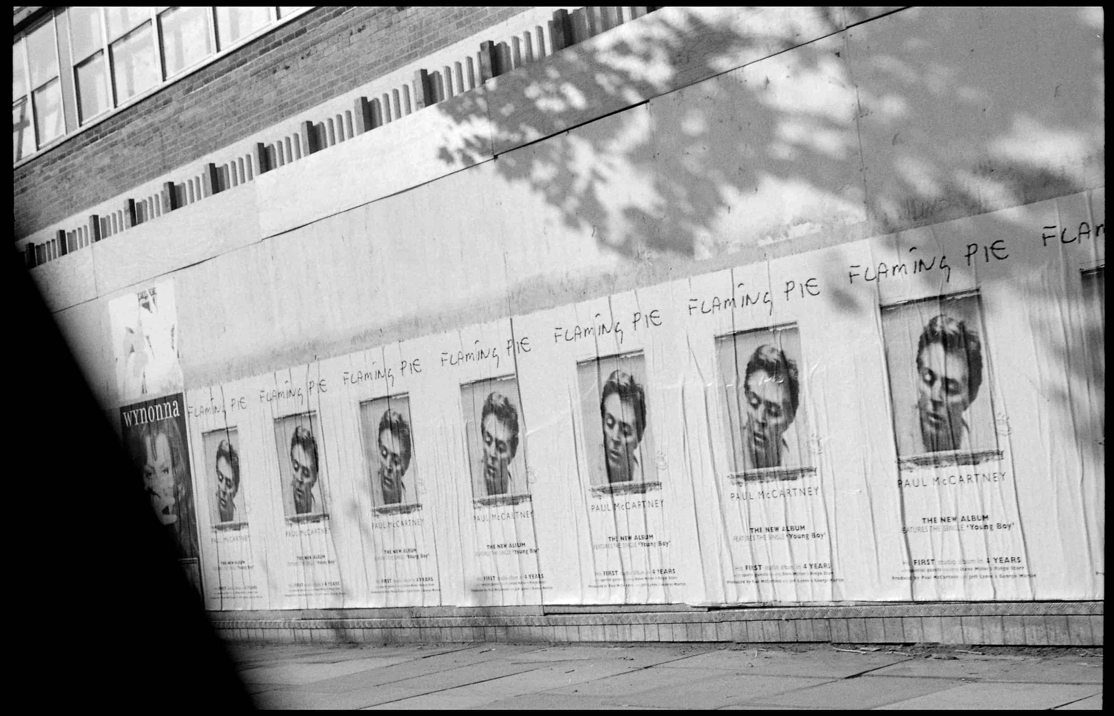 black and white photo of the 'Flaming Pie' marketing posters, taken from a car window by Linda.