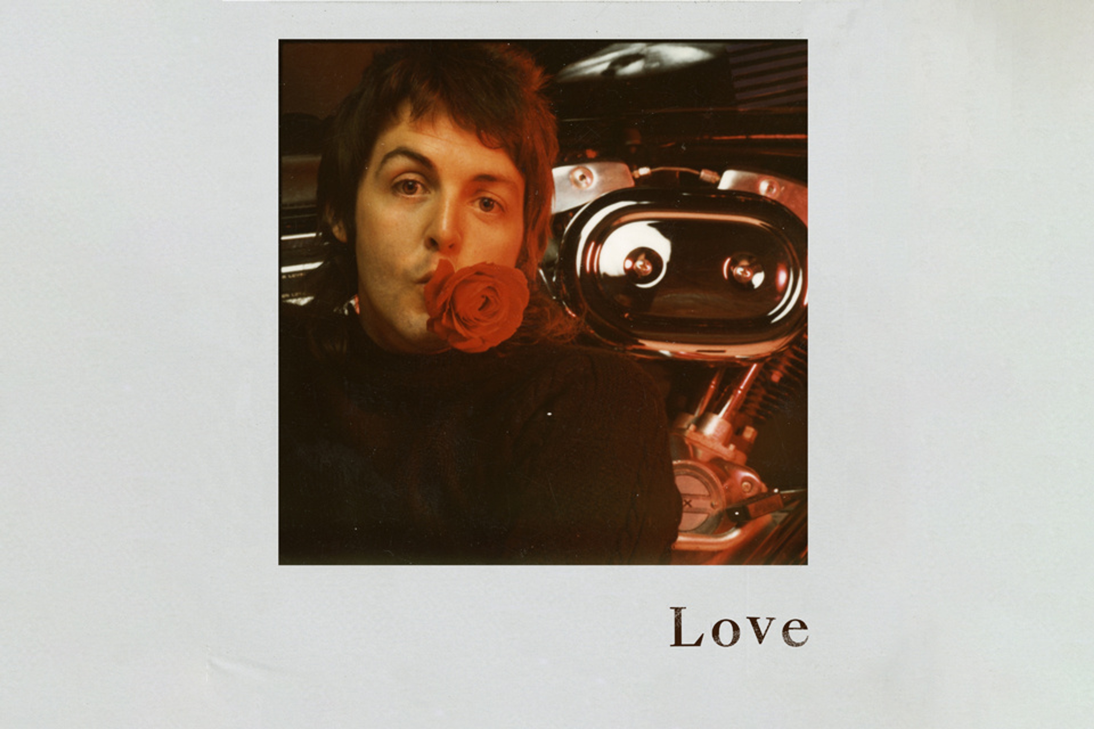 Photo of 'Love' EP artwork which includes a portrait of Paul with a rose in his mouth.