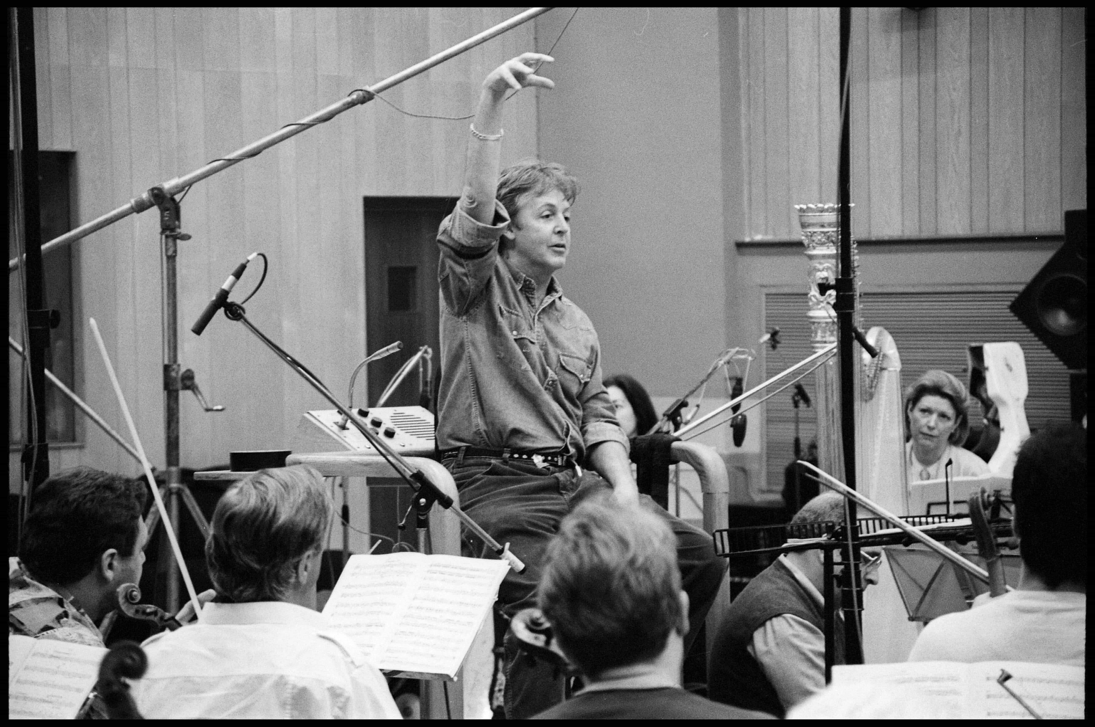 Black and white photo of Paul conducting an orchestra