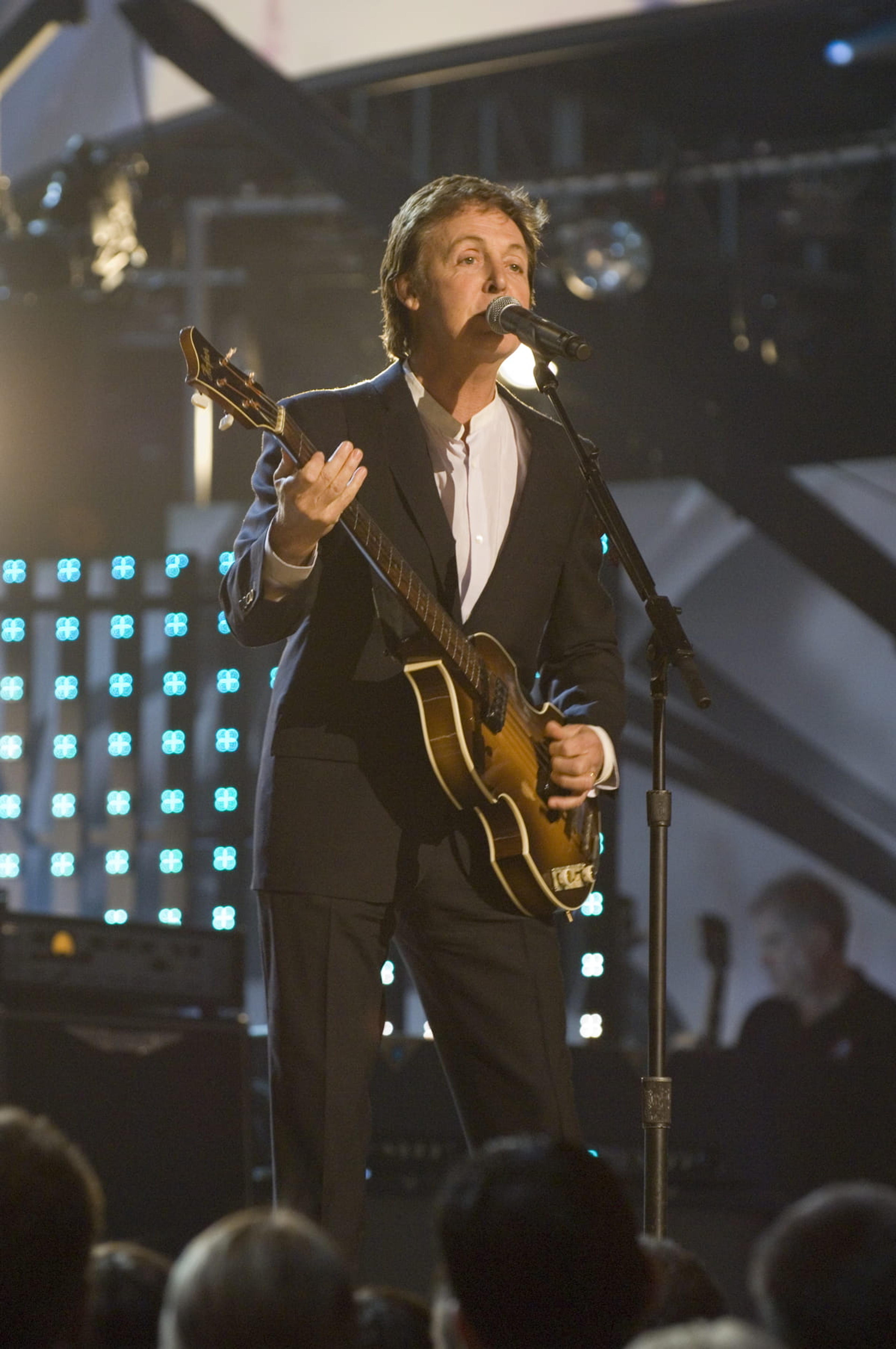 Paul standing on stage holding a bass guitar