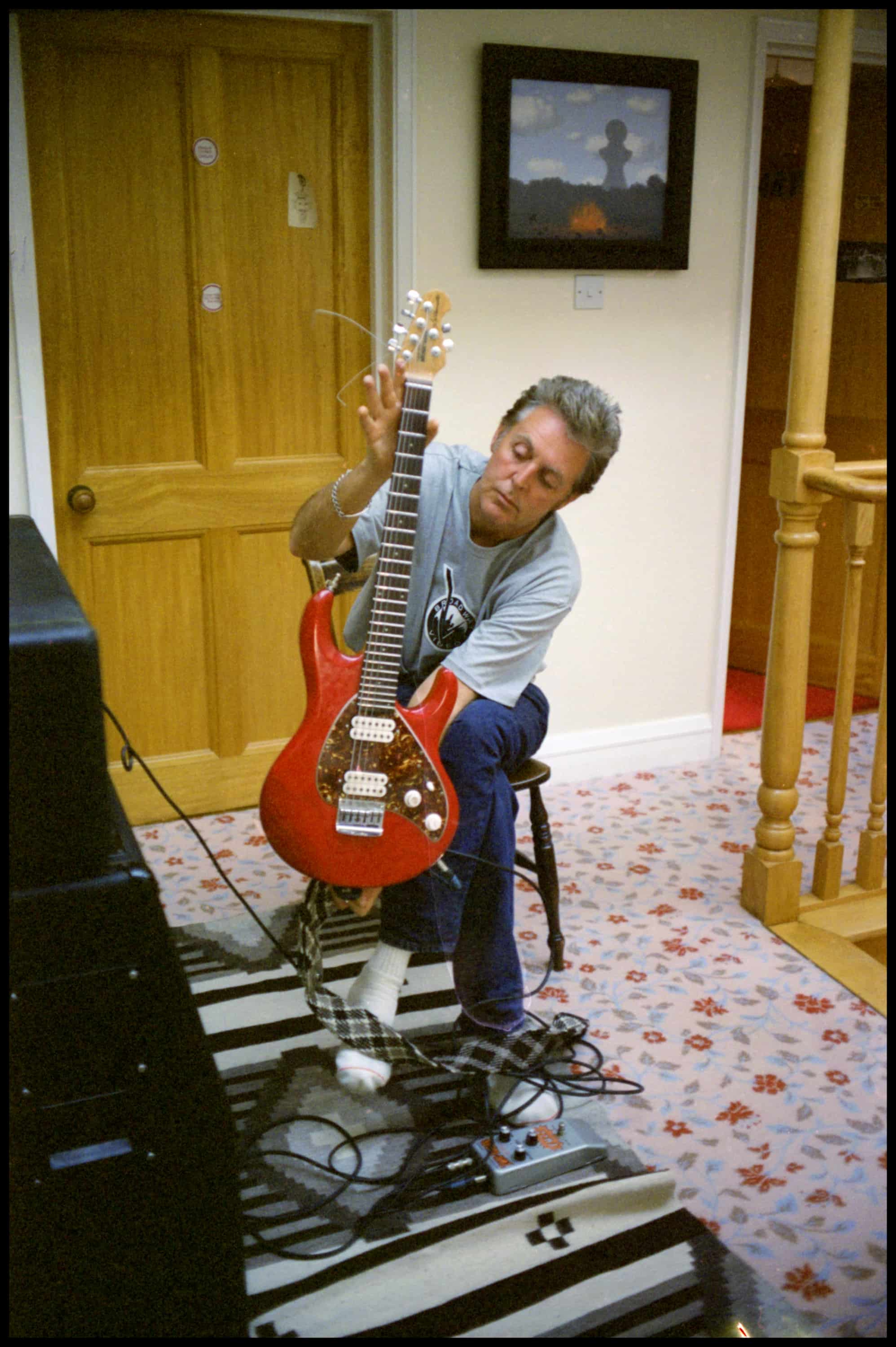 Colour photo of Paul McCartney holding a guitar