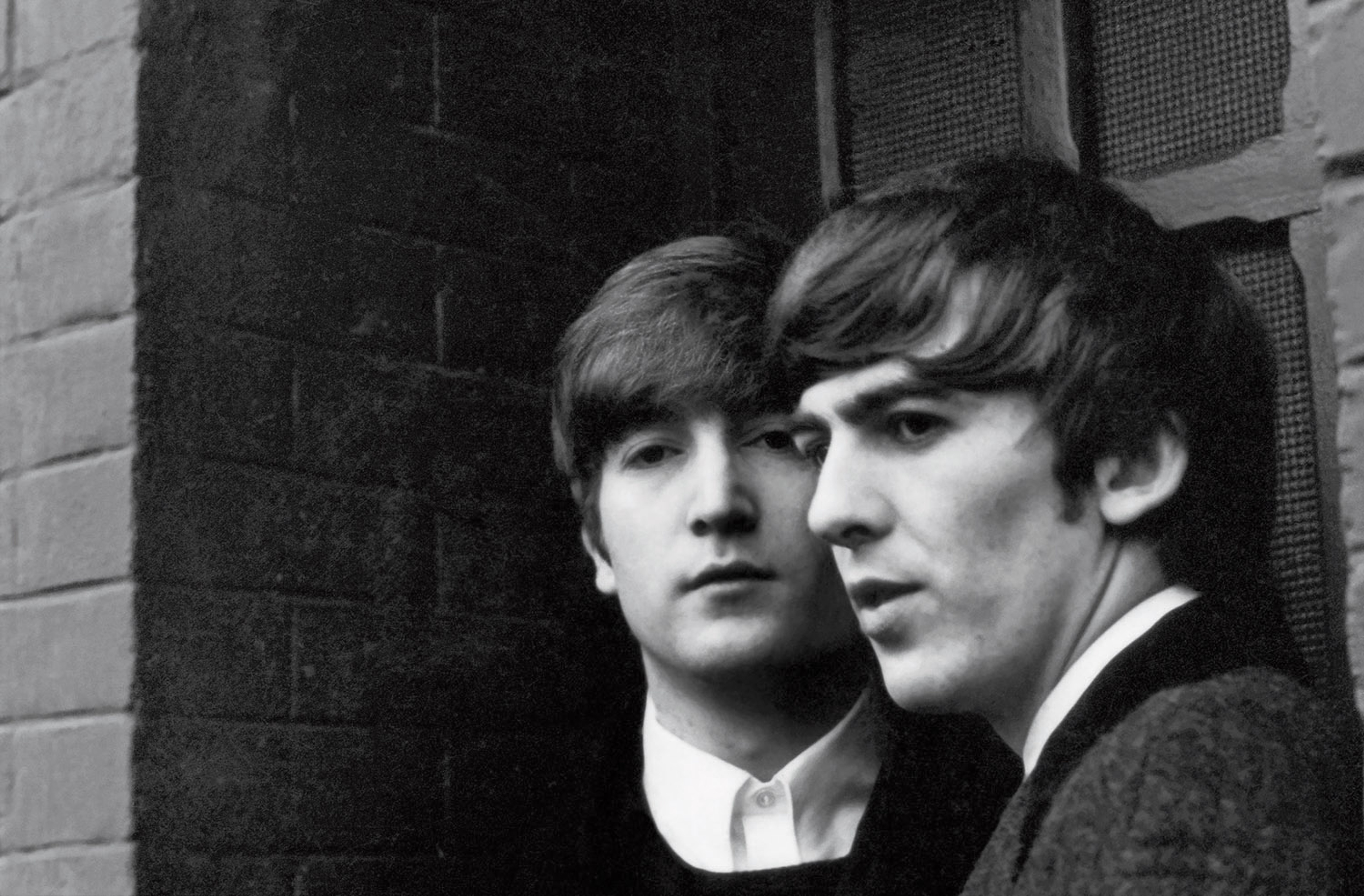 Black and white photograph of John Lennon and George Harrison in Paris