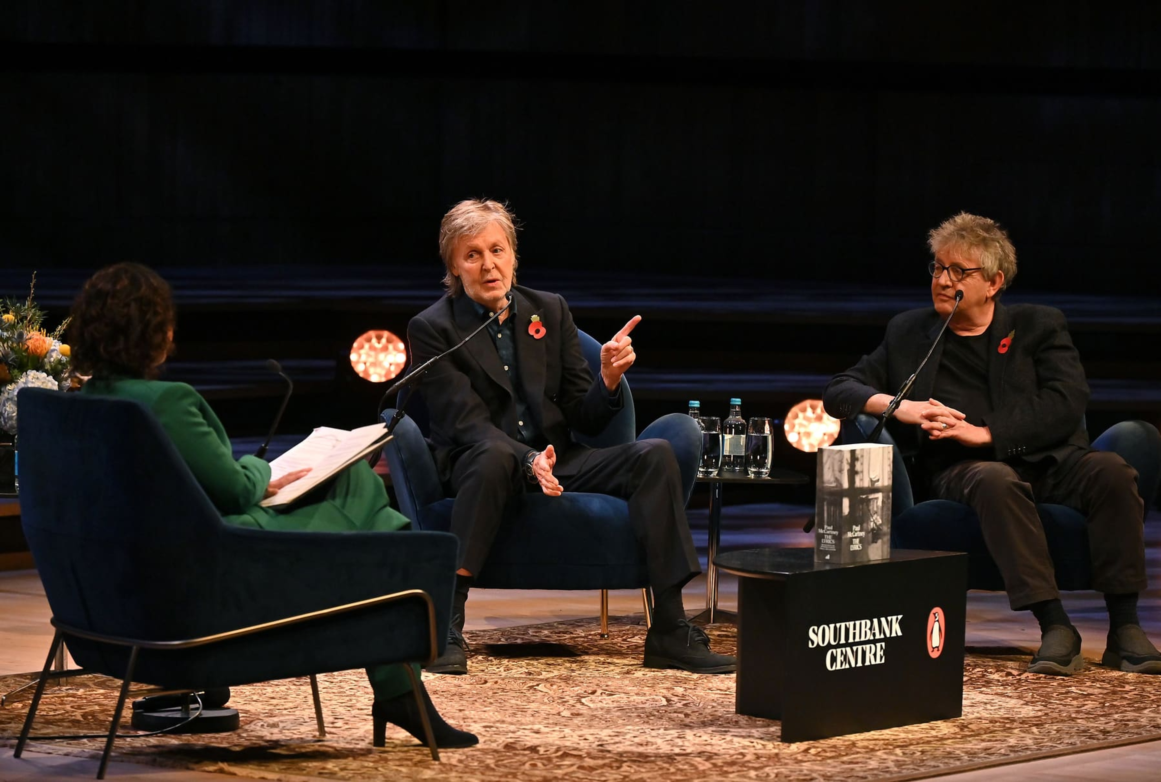 Photo of Samira Ahmed, Paul McCartney and Paul Muldoon sat in conversation at the Royal Festival Hall stage.