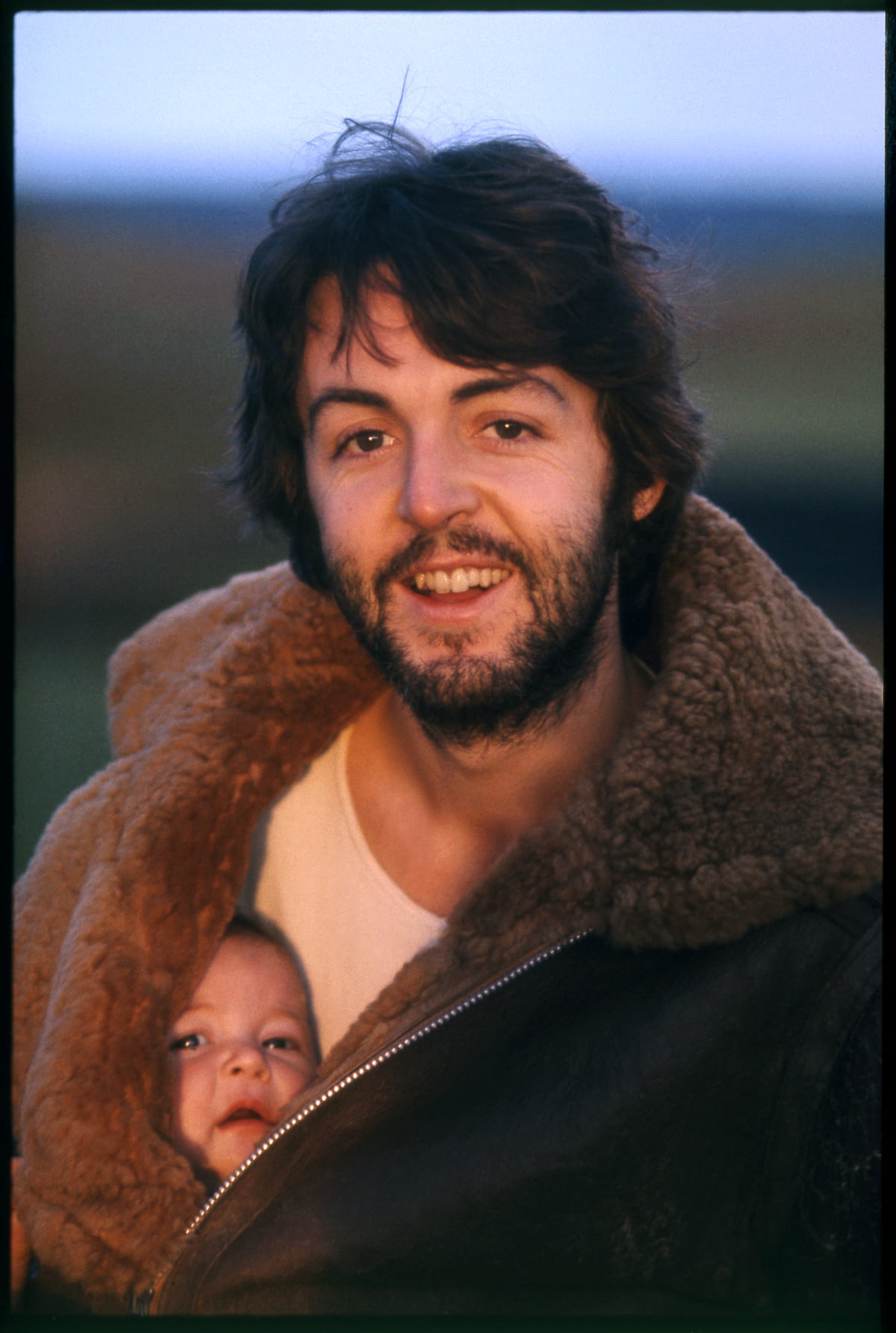 Photo of Paul McCartney and baby Mary McCartney in his coat jacket. Used on the back cover of 'McCartney'