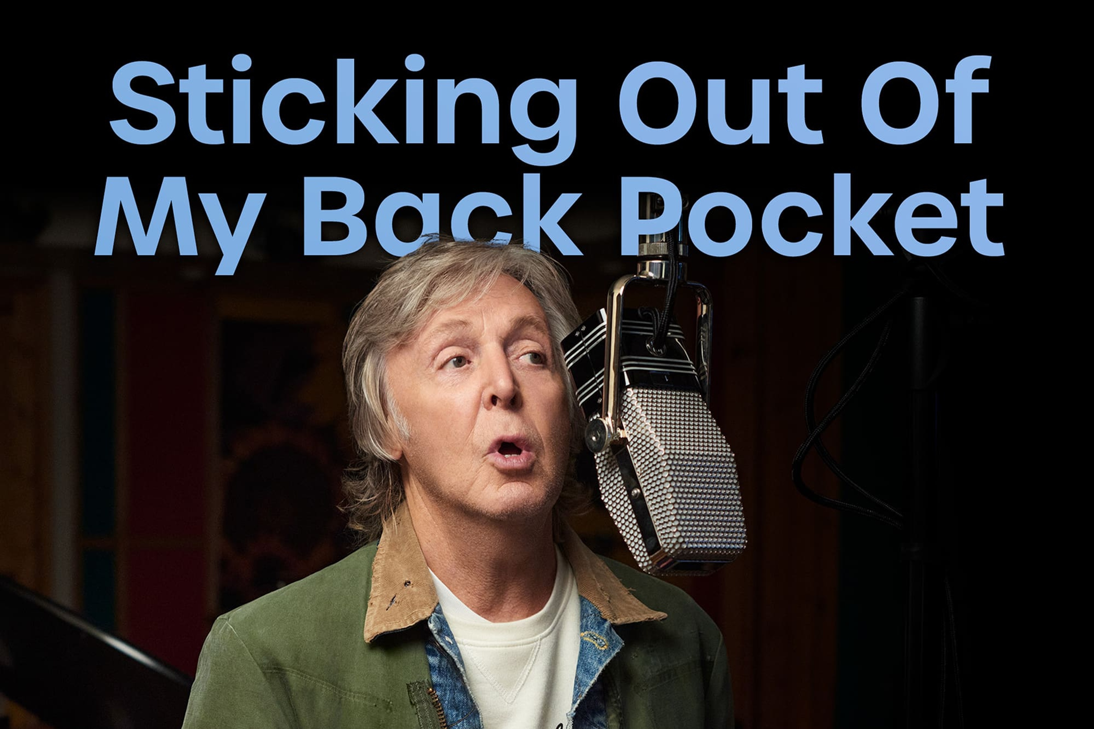 Photo of Paul McCartney in the studio with 'Sticking Out Of My Back Pocket' text across it.