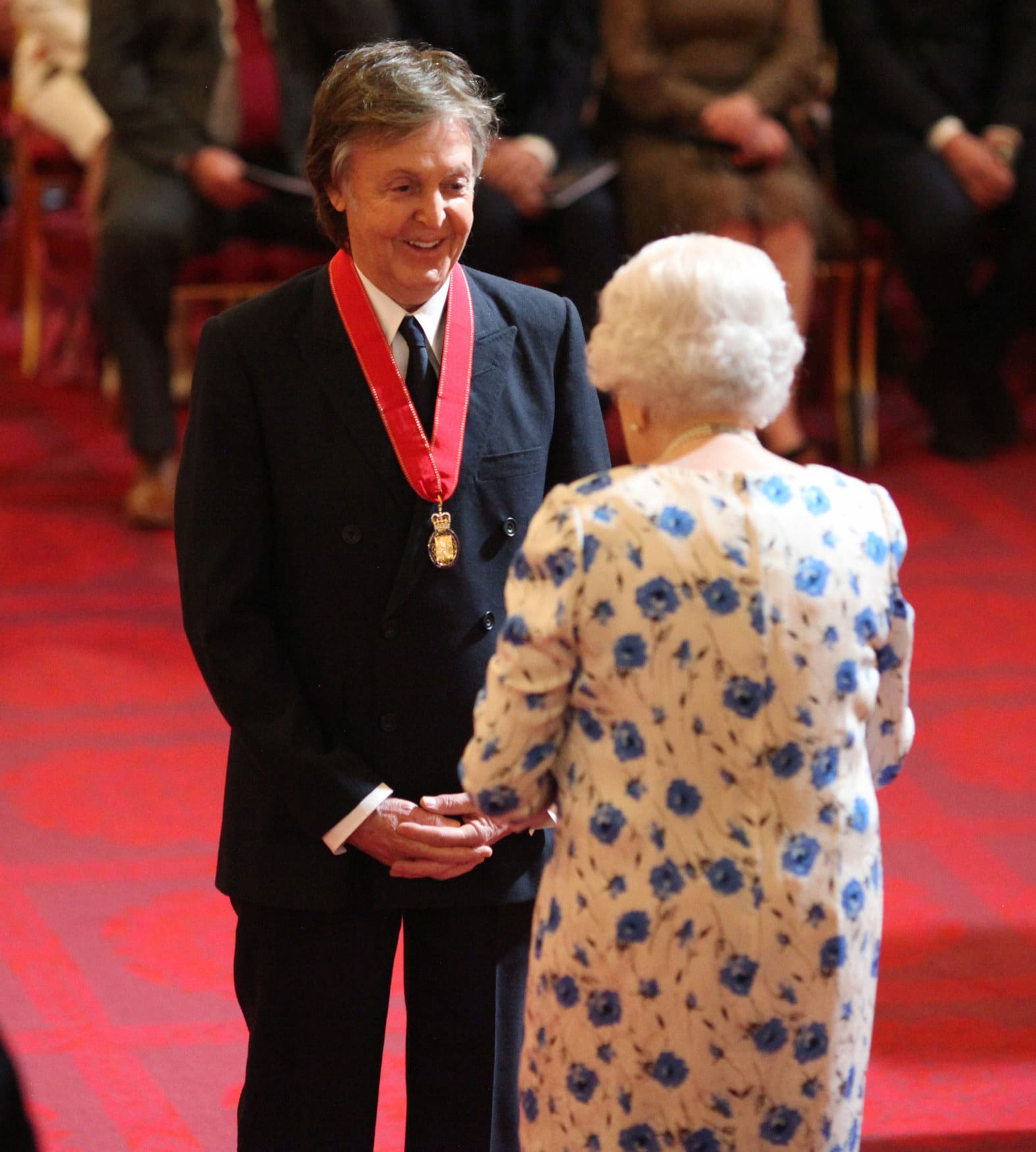 Photo of Paul at Buckingham Palace being made a Companion of Honour by Queen Elizabeth II.