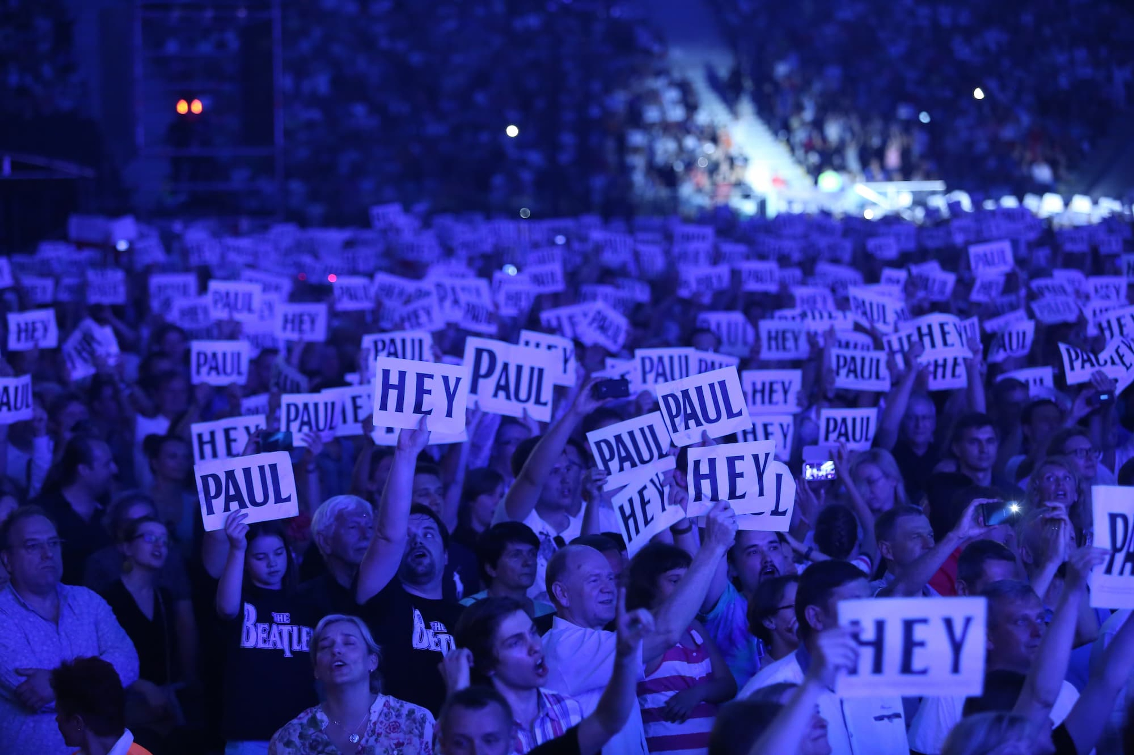 Photo of the crowd during the 'Out There' tour at Warsaw in 22nd June 2013 holding signs saying "Hey Paul"