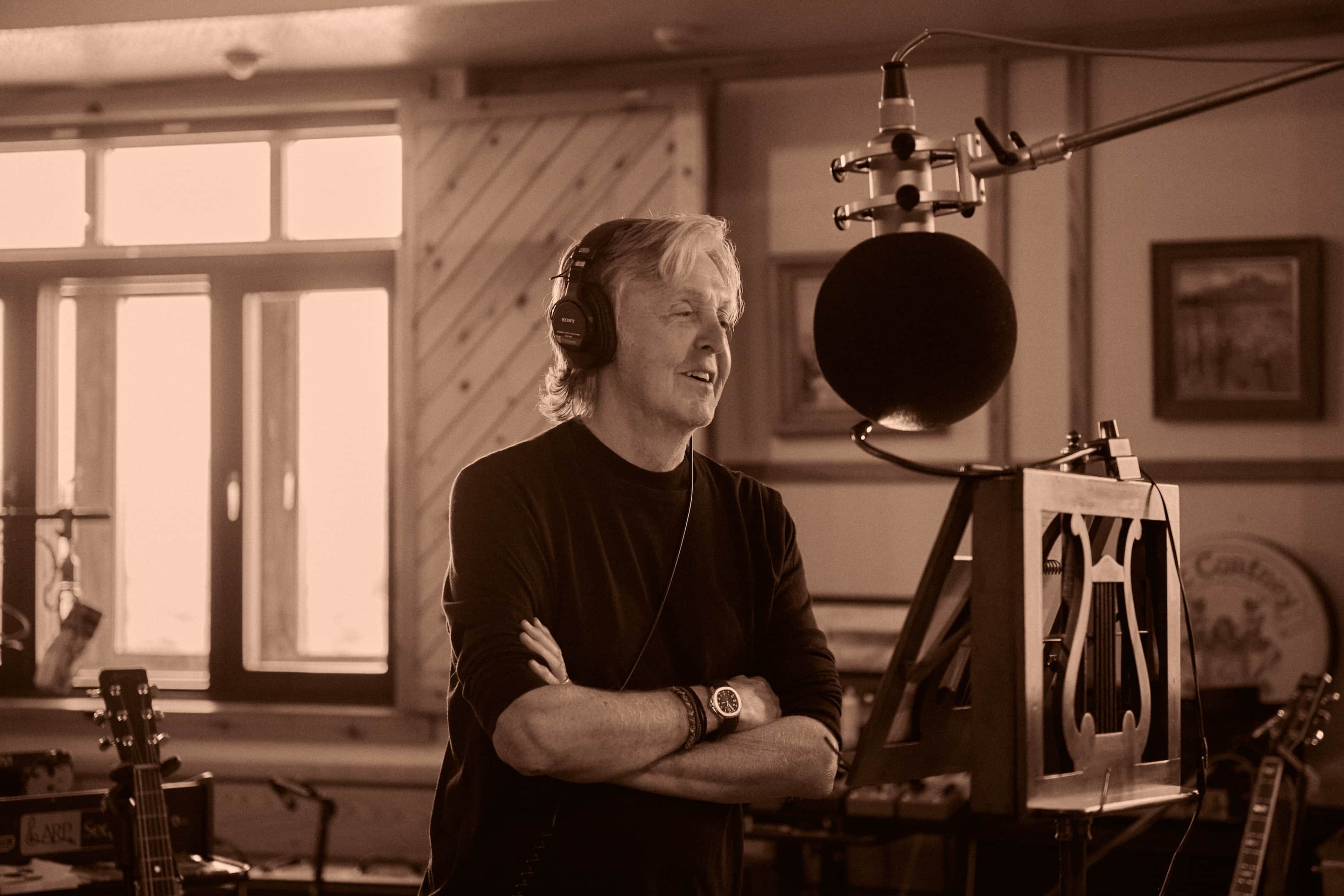 Sepia photo of Paul at the mic stand recording 'McCartney III'