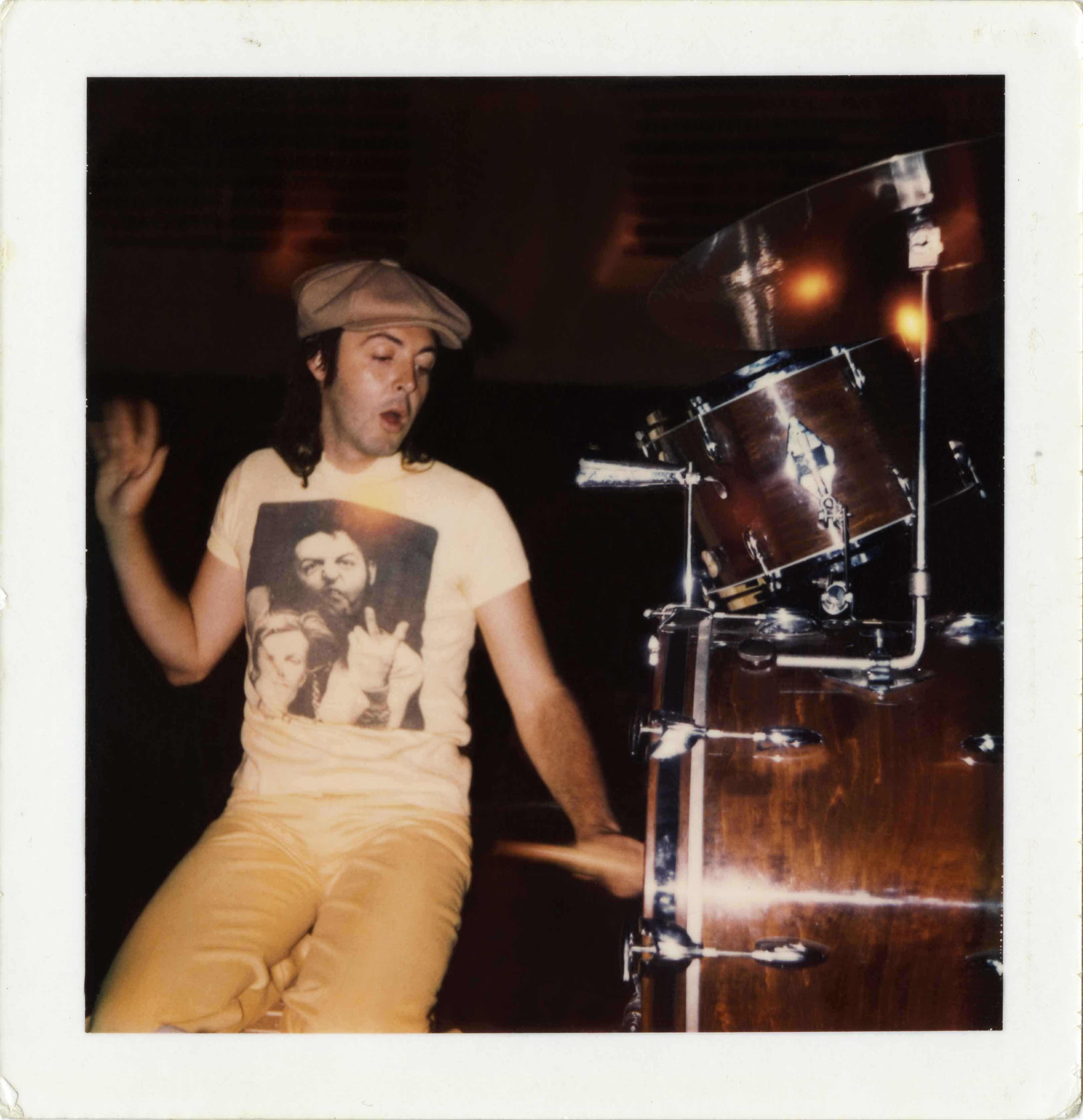 Paul posing next to a drum kit