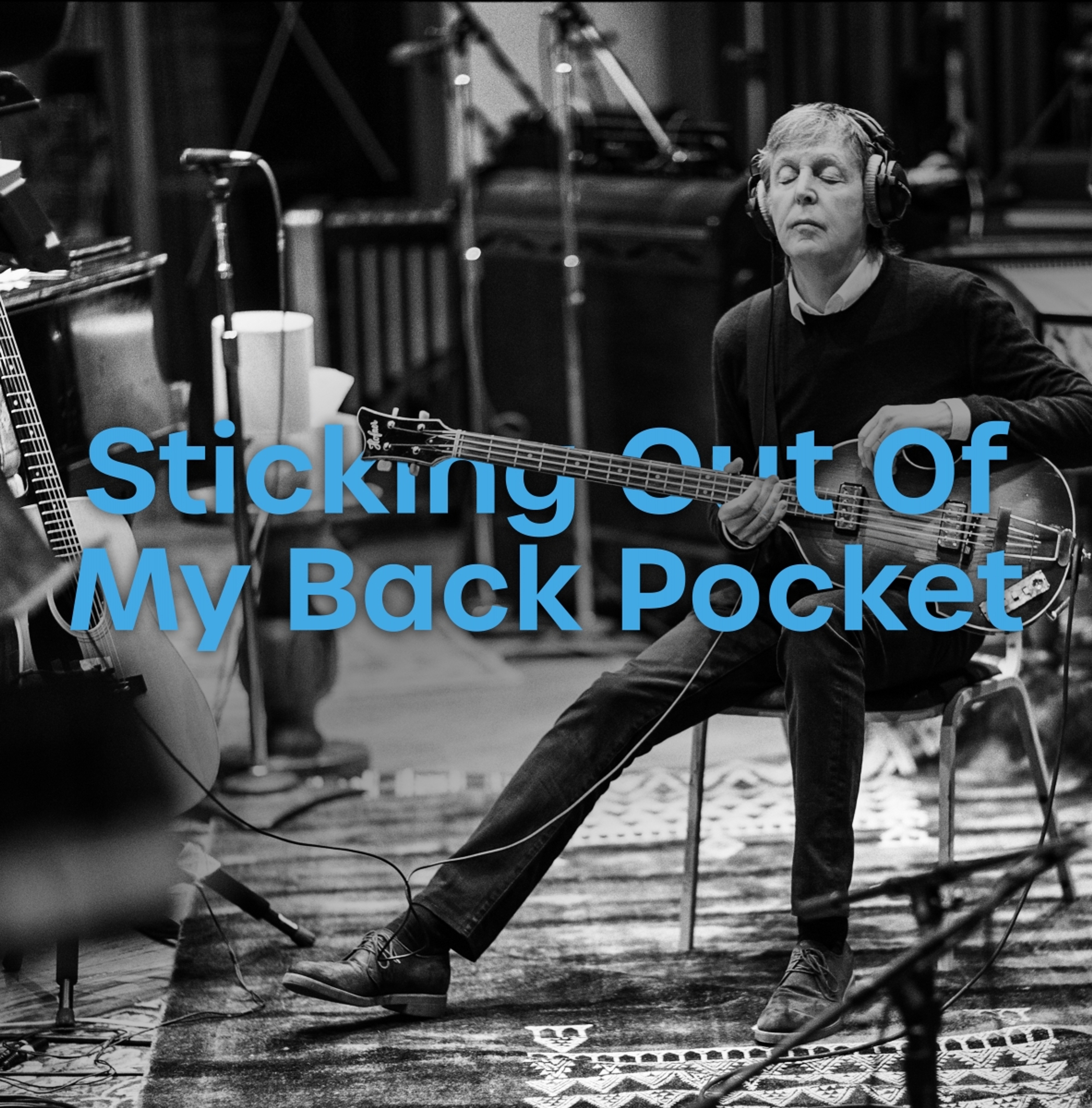 Photo of Paul playing guitar used for the 'Sticking Out Of My Back Pocket' playlist