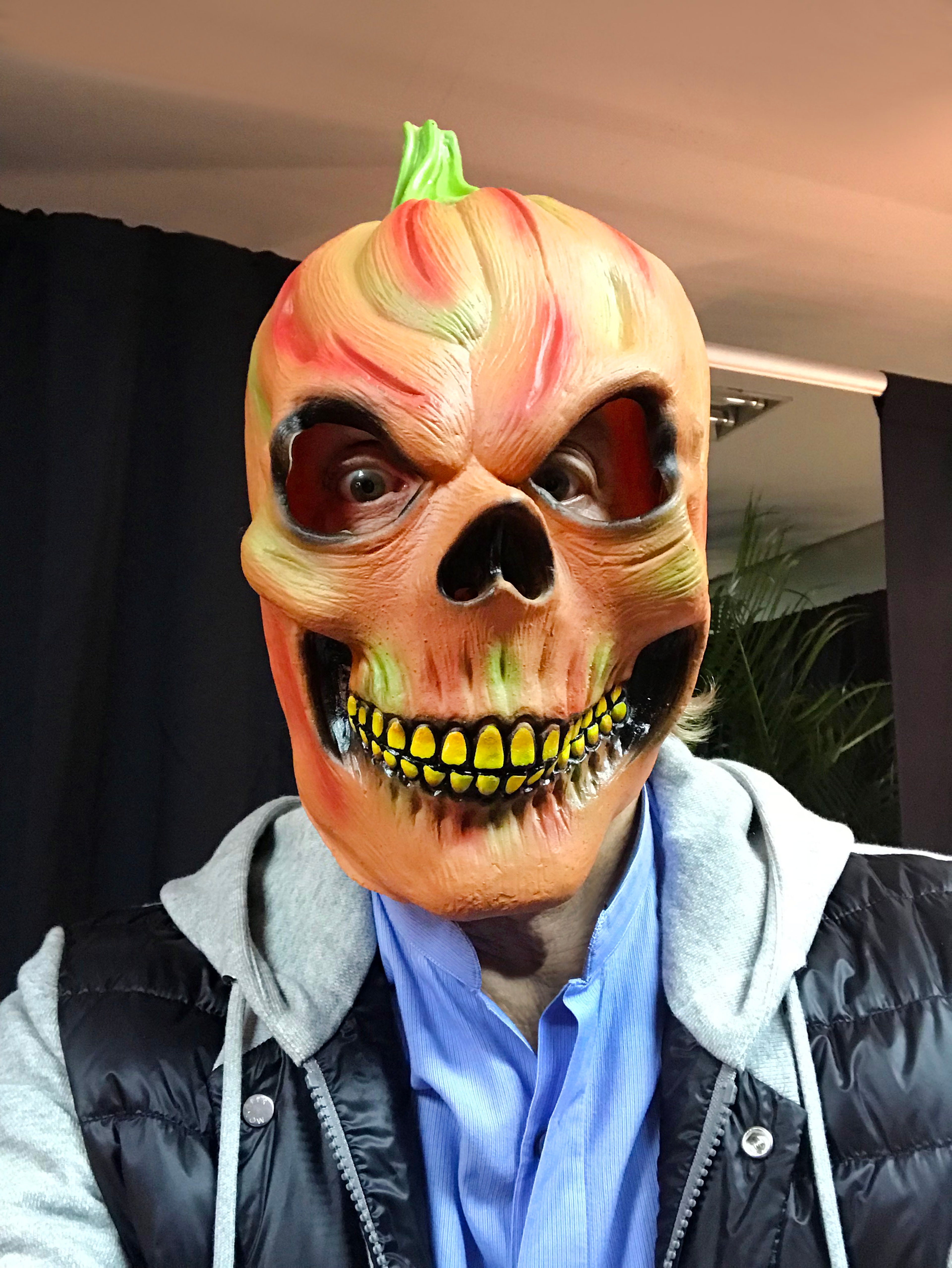 Photo of Paul wearing a spooky pumpkin mask to celebrate Halloween
