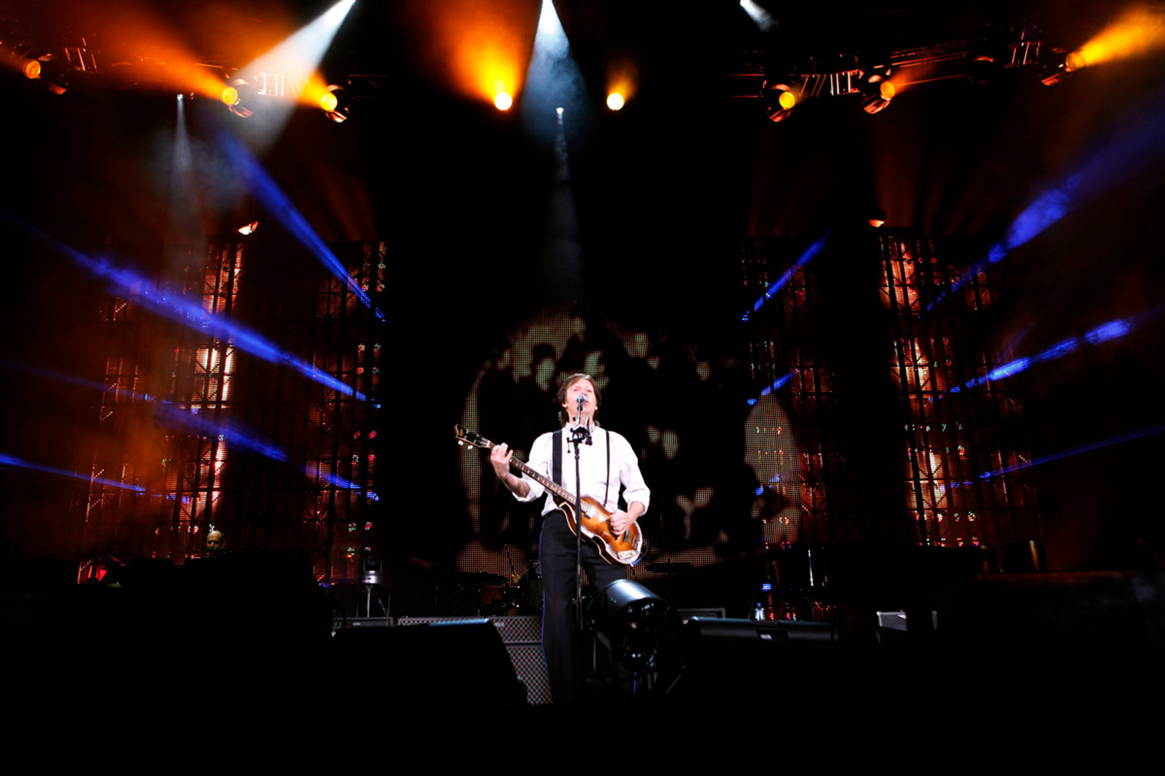 Paul on stage with the cover of 'Band on the Run' on the screen behind him, Minute Maid Park, Houston, 14th November 2012