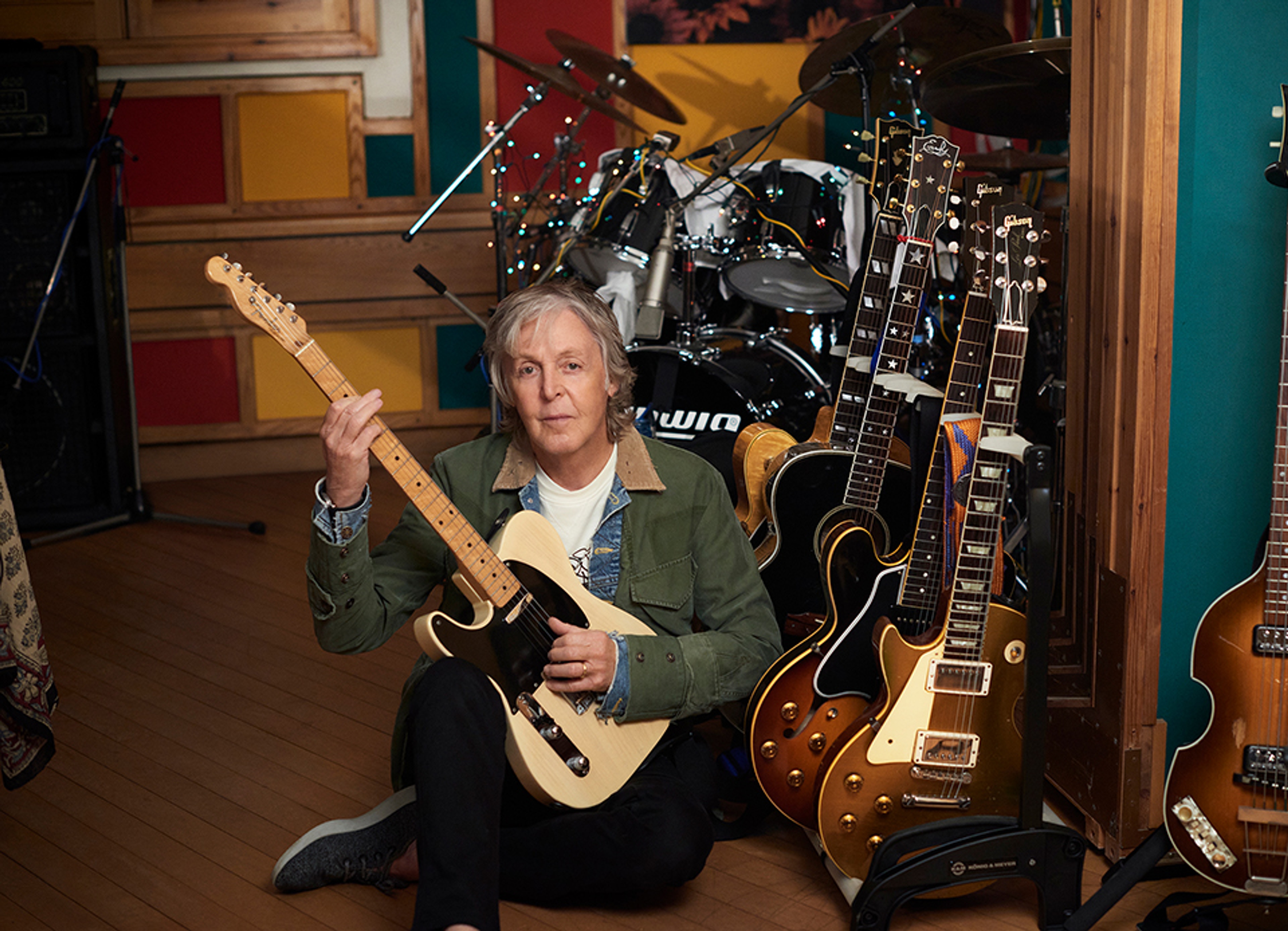 Photo of Paul at the guitar rack in his studio in Sussex during the recording of 'McCartney III'