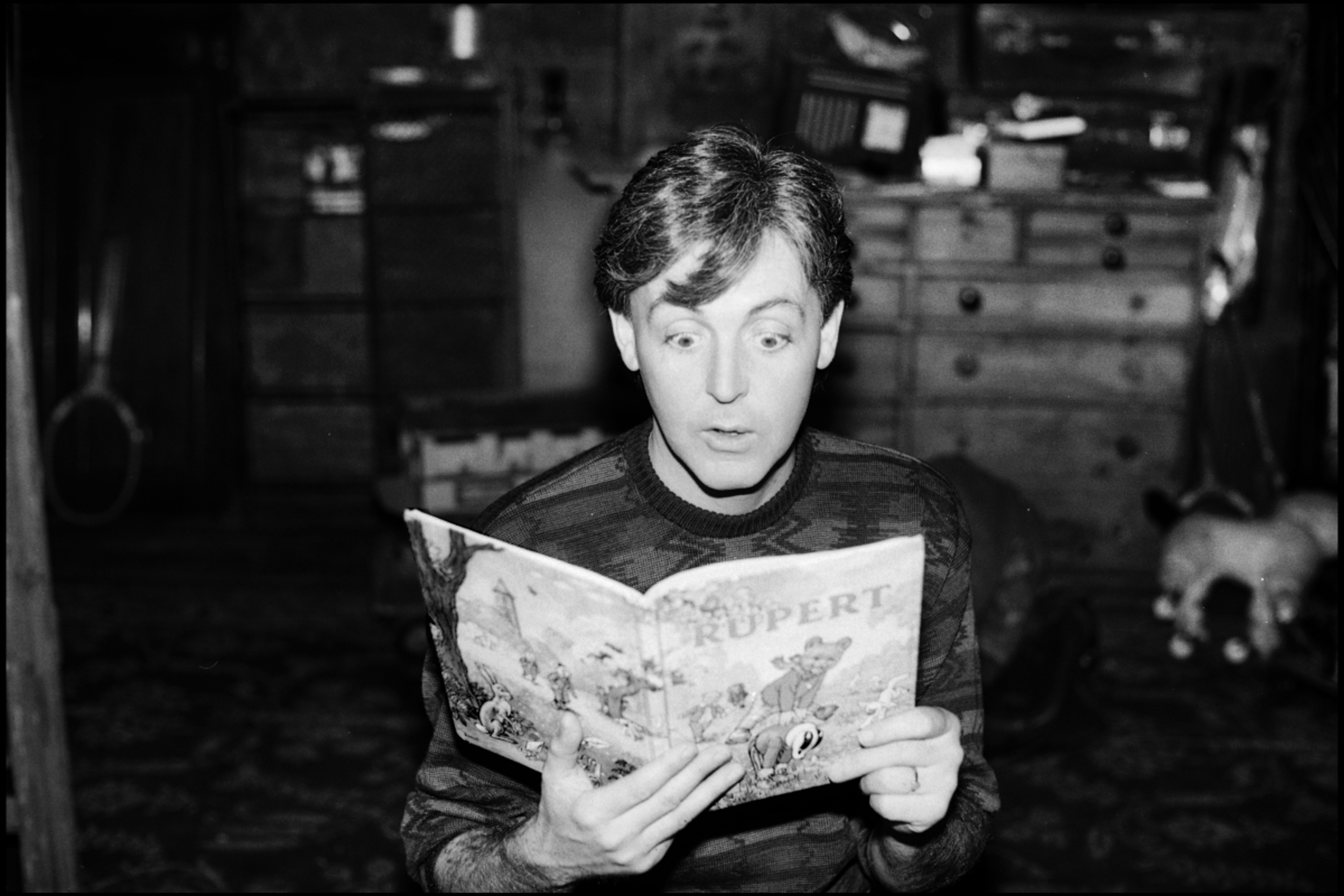 Paul reading his Rupert annual in the 'We All Stand Together' music video