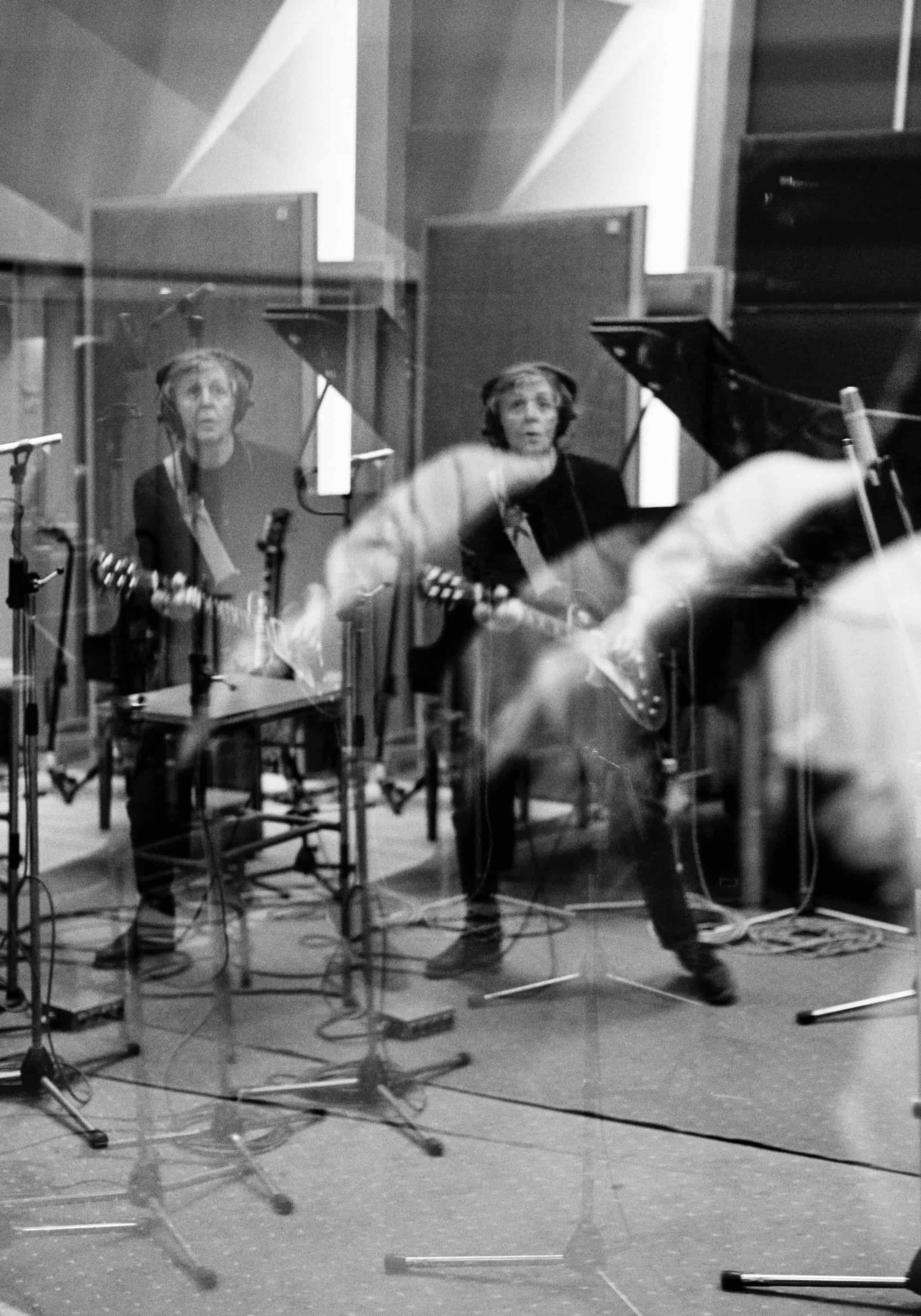 Photo of Paul playing guitar in Abbey Road Studios, taken through a prism. 