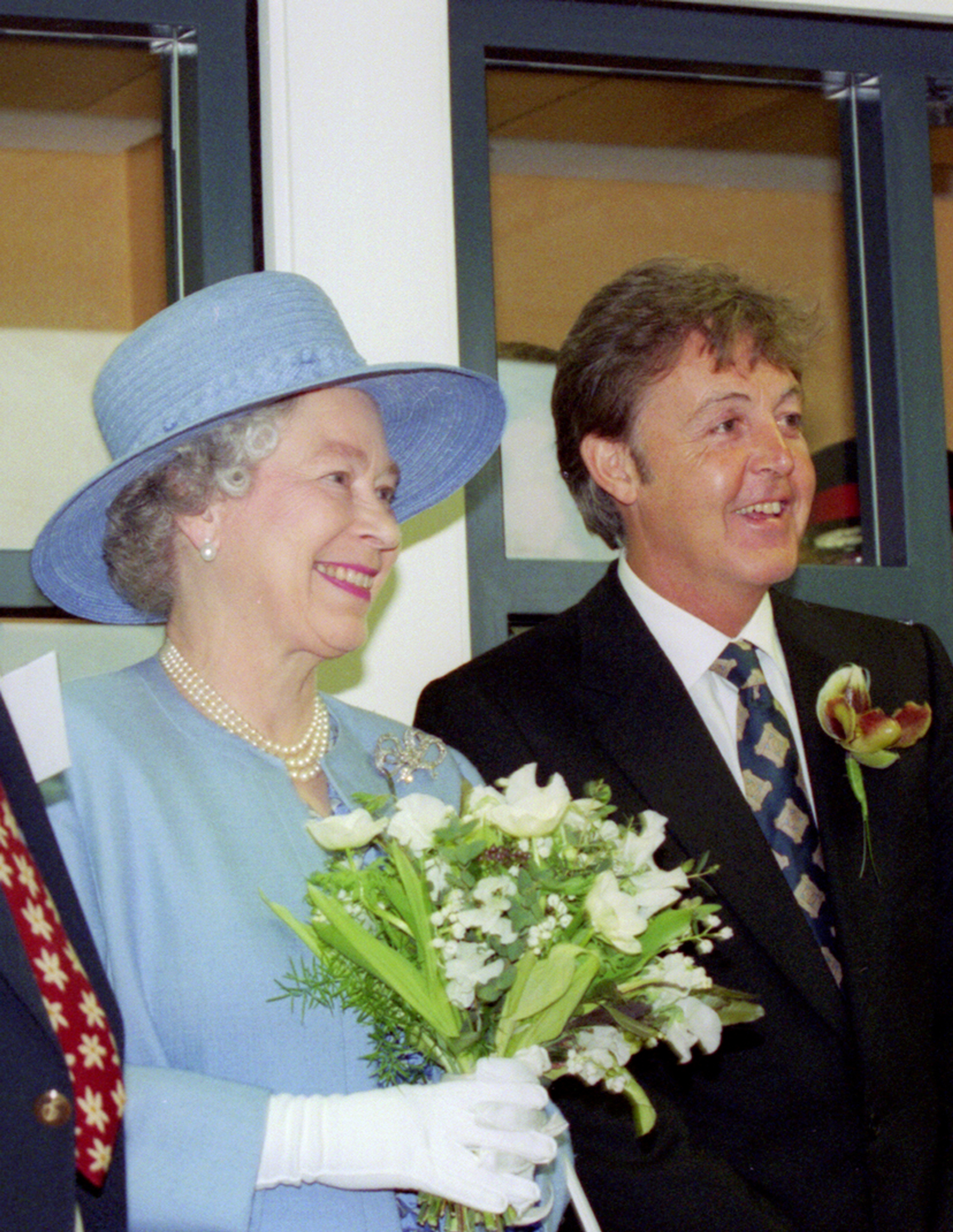 Photo of HRH Queen Elizabeth II with Paul McCartney at the opening of LIPA (Liverpool Institute for Performing Arts) 