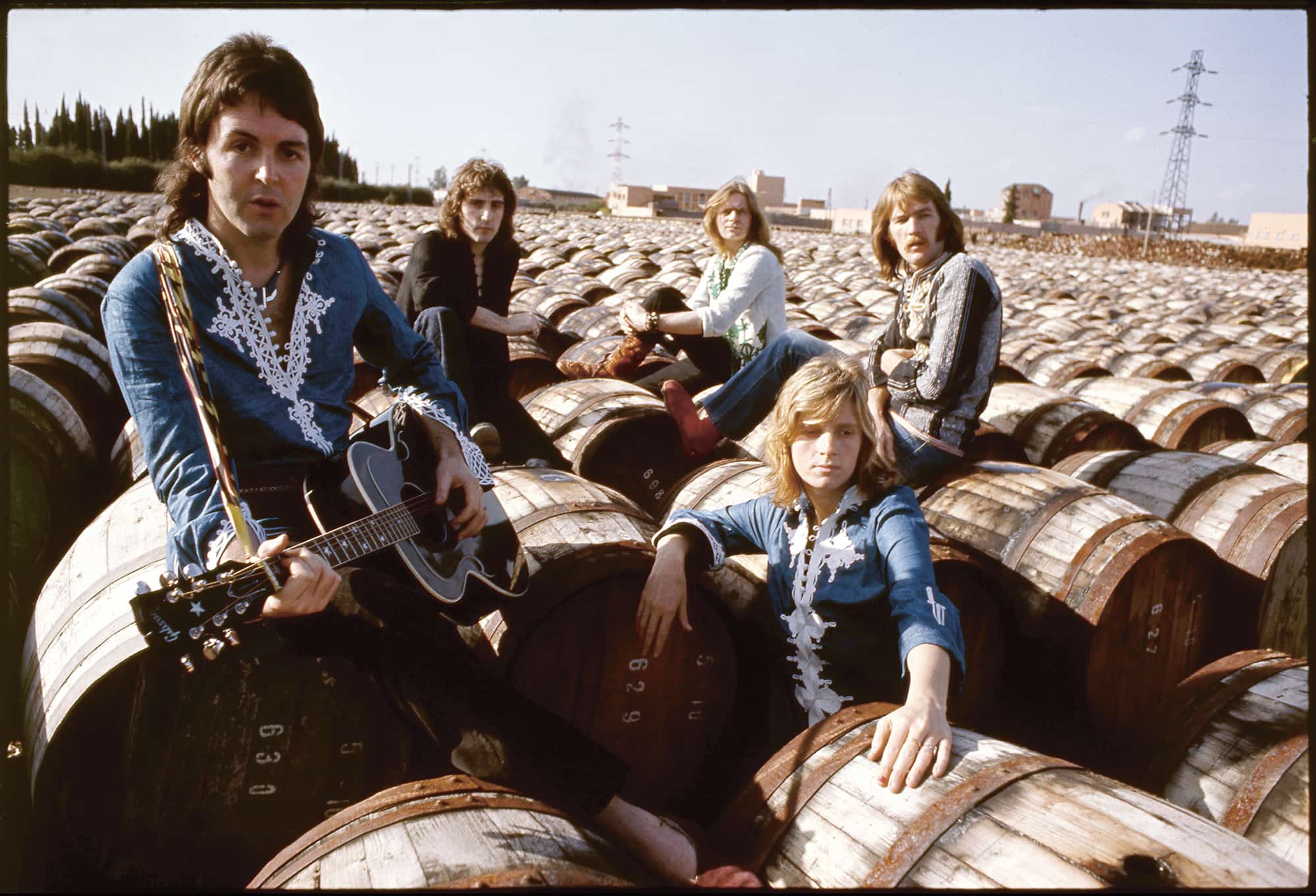 Wings band members sat on barrels 