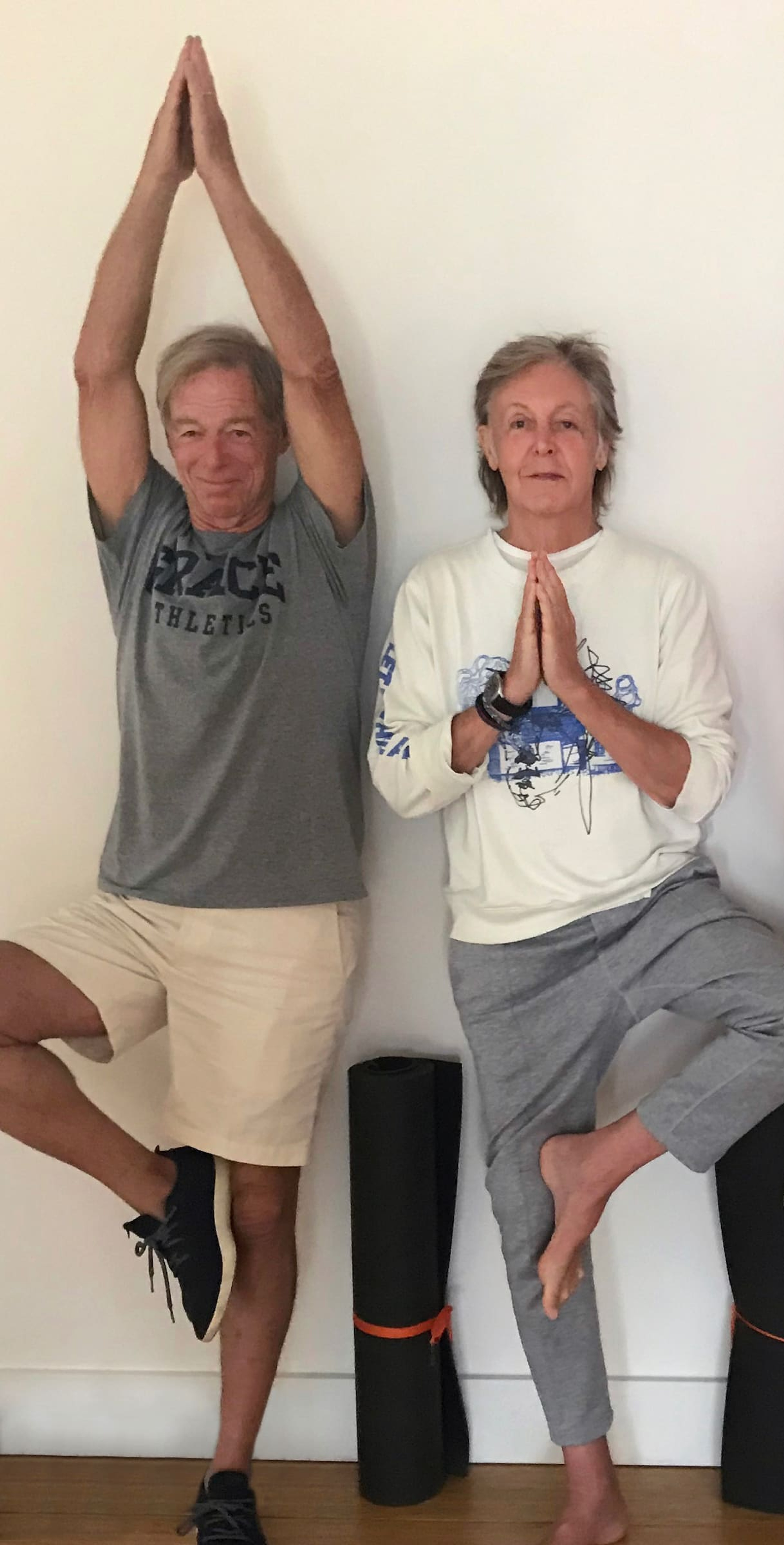 Photo of Paul and John Eastman doing yoga