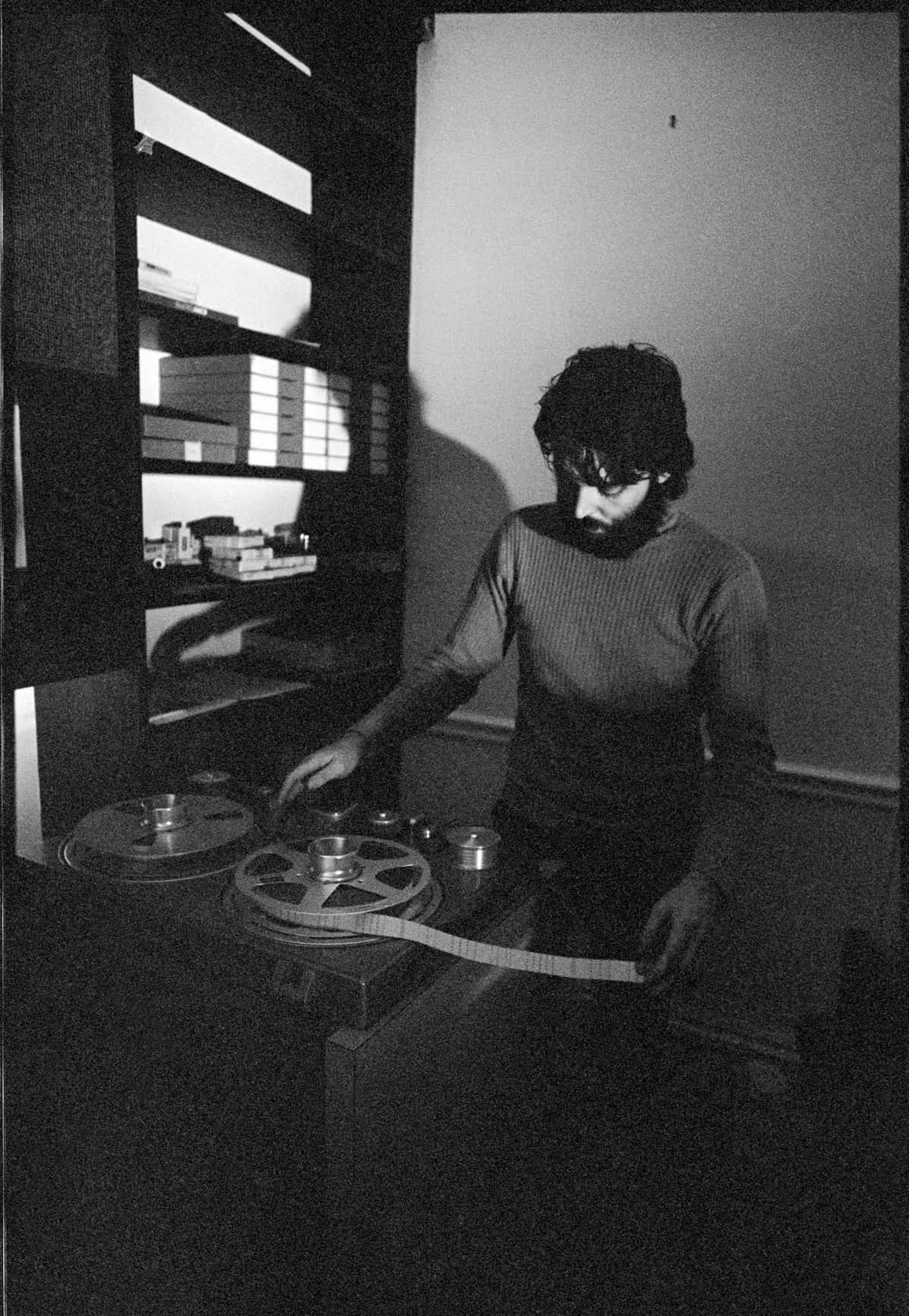 Black and white photo of Paul at his  Studer tape machine set up