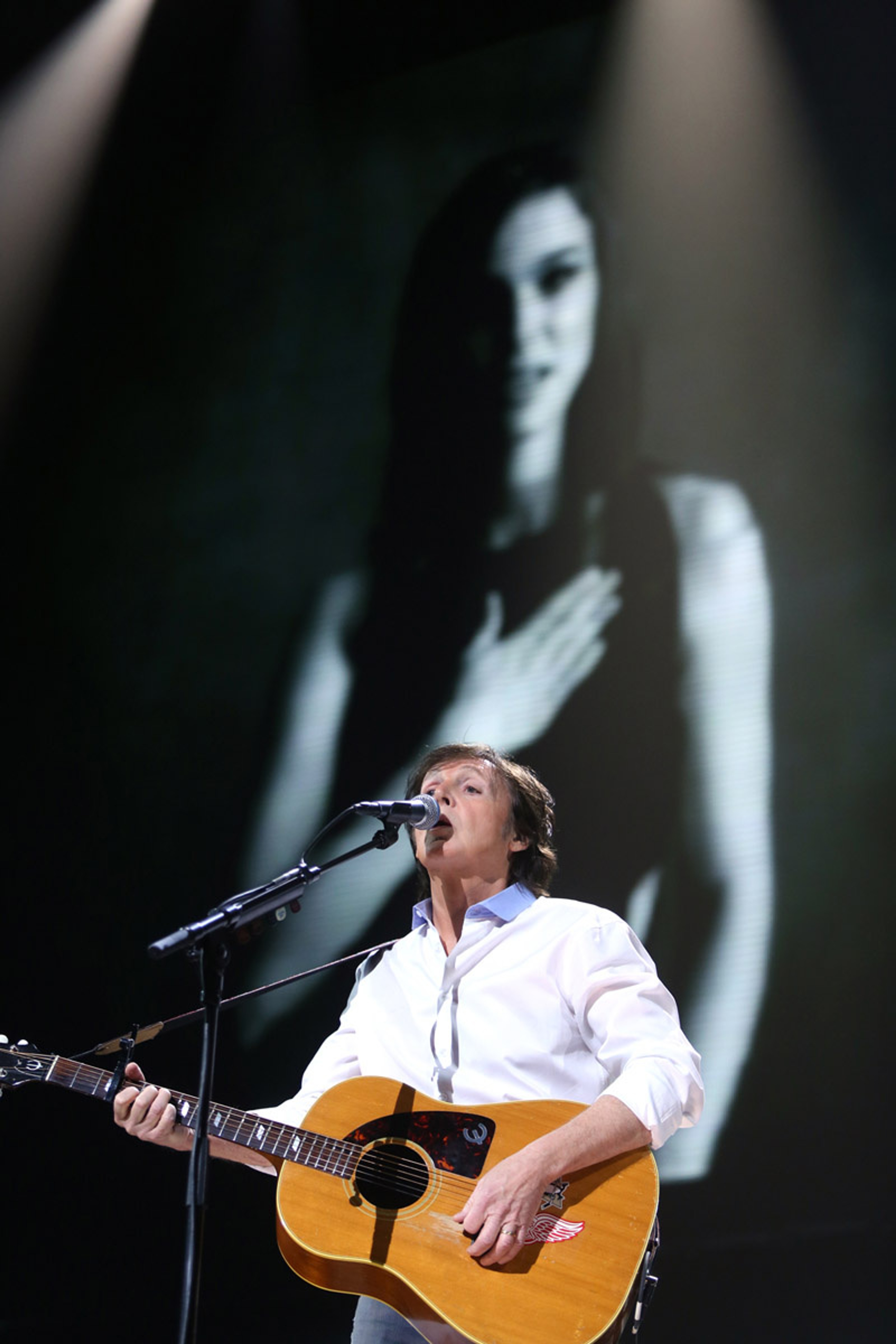 Paul with Natalie Portman on the screen during 'My Valentine', 12-12-12 Hurricane Sandy Benefit, Madison Square Garden, NYC, 12th December 2012