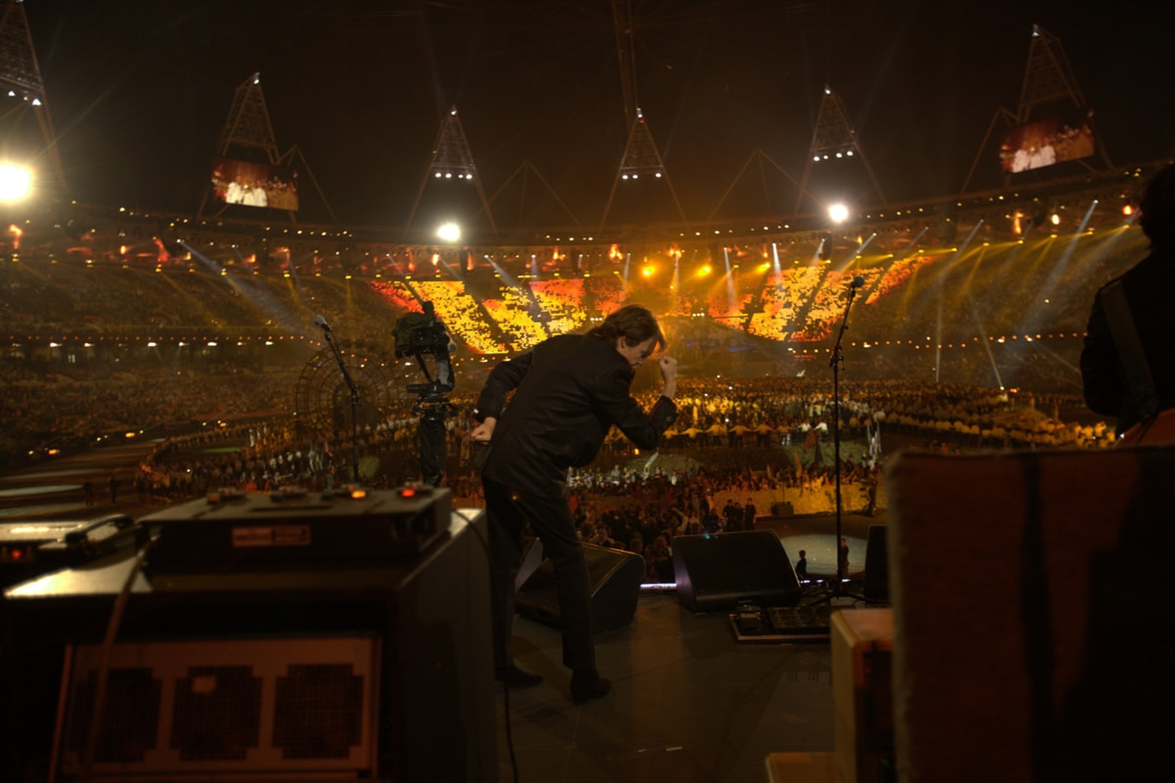 Paul mimicking Usain Bolt's lightning pose on stage at the Olympic Opening Ceremony rehearsals, London, 24-Jul-12