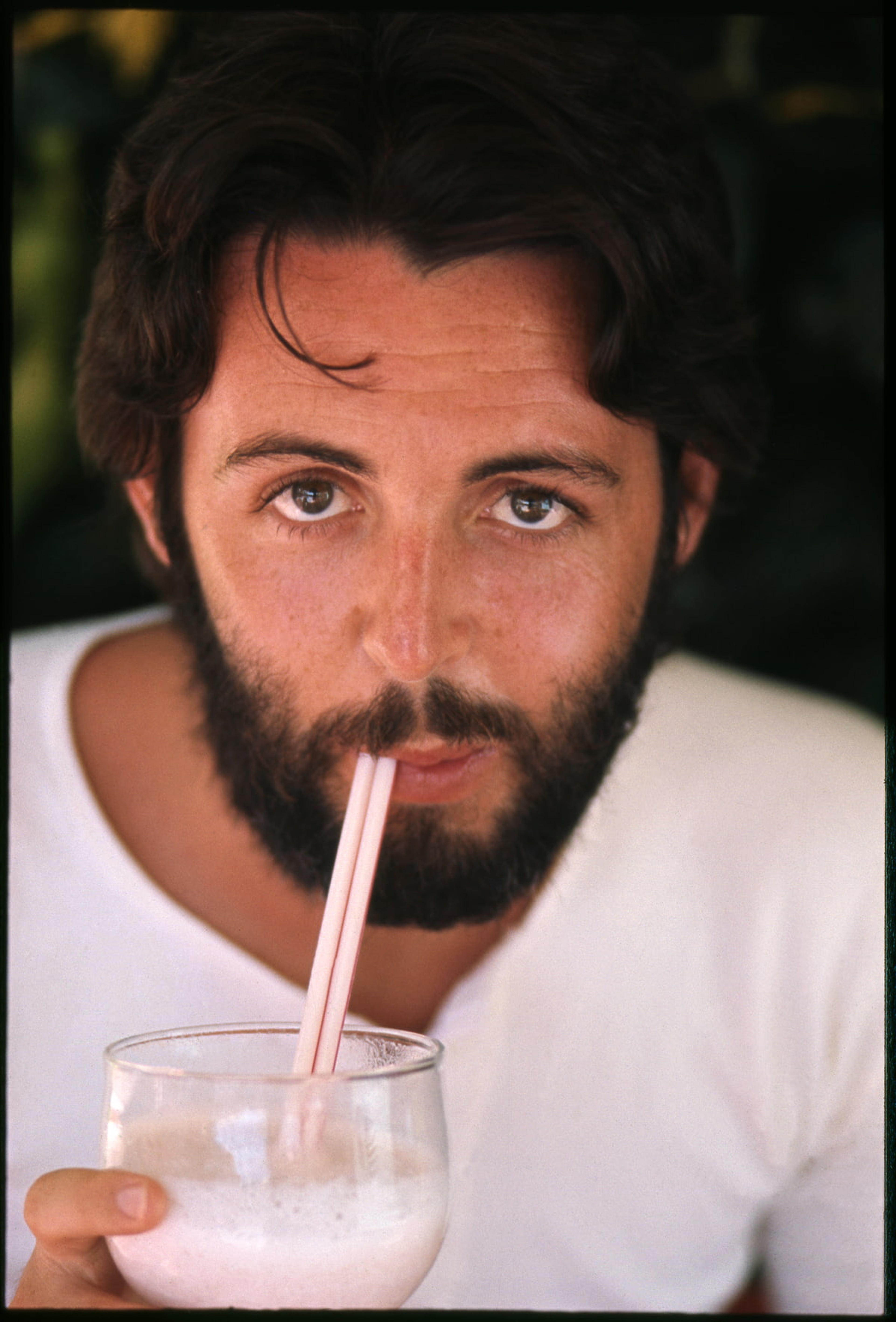 Portrait of Paul with a drink in his hand and a straw