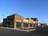 Left corner view of Verizon Wireless store on a sunny day. Building is stone, brick, and metal.