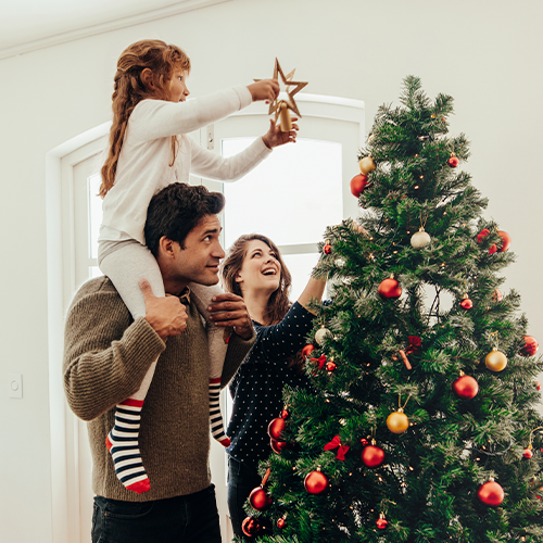 Family decorating a Christmas Tree