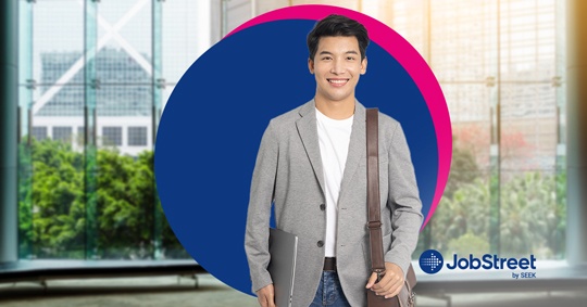 A young professional holding a laptop and bag