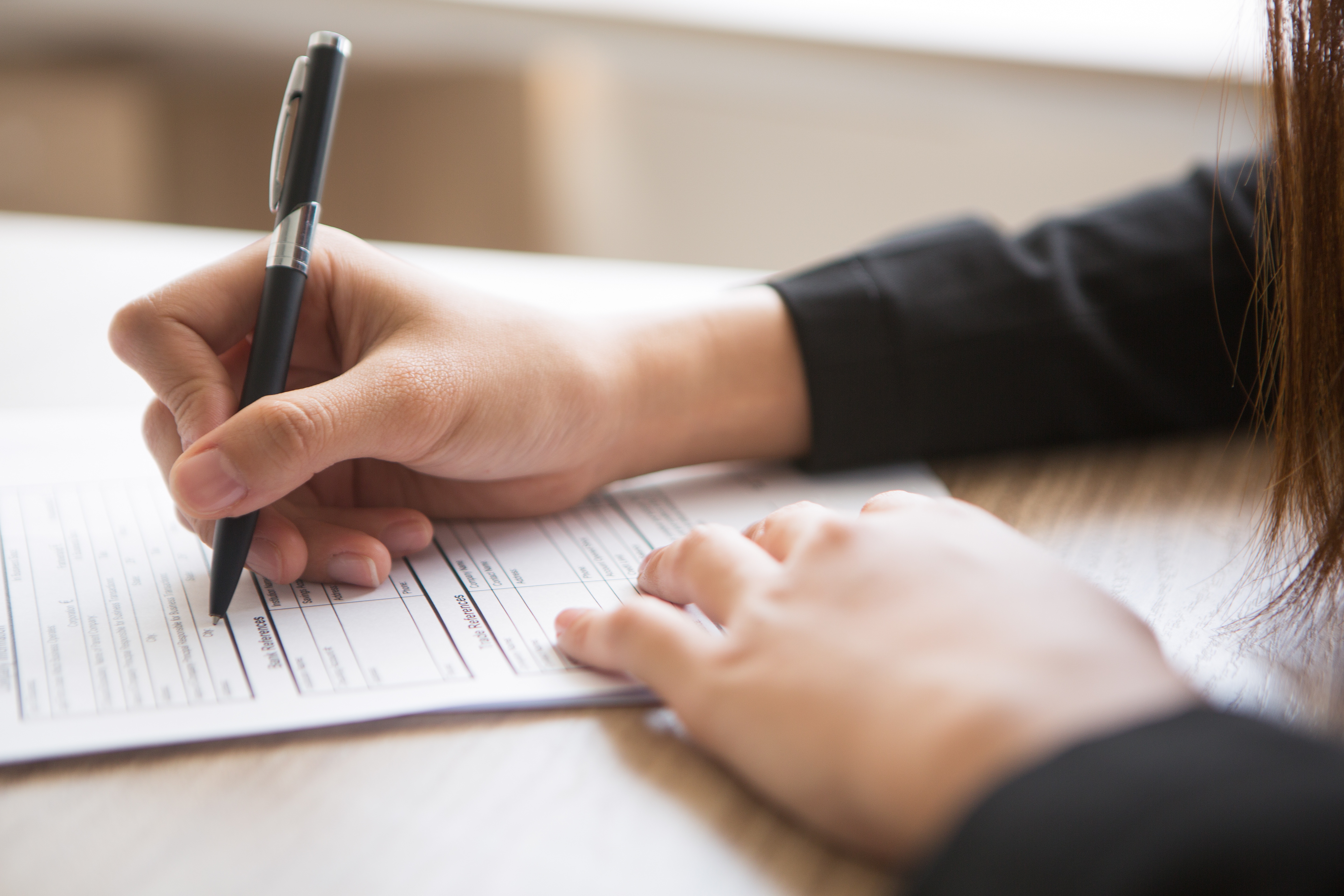 Cropped view of woman filling in a job application form