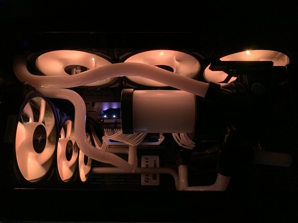 Front shot of Lian Li O11D custom loop with white coolant and orange lighting