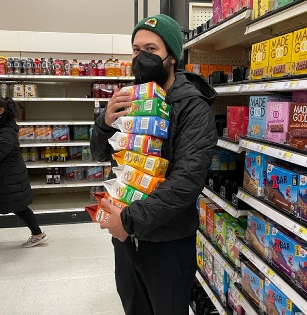 A dude holding a bunch of Goldfish crackers.