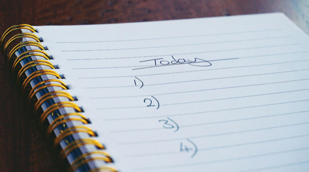 A notebook listing daily to-dos helps with work productivity 