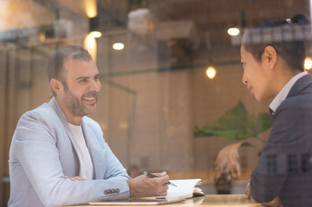 men at work talking to each other