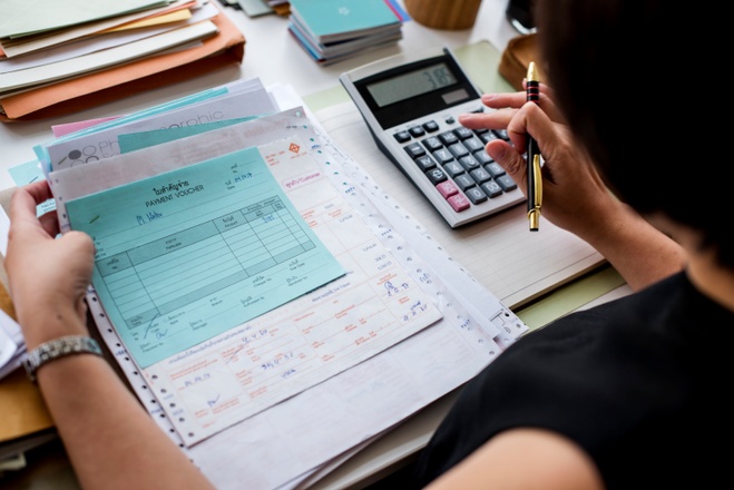 asian-woman-working-through-paperwork.jpg