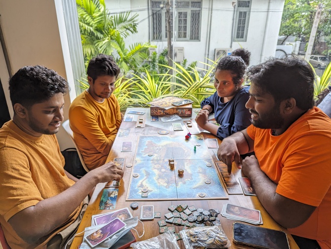A bunch of people having fun playing Jamaica the board game