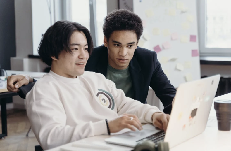 Employees crafting good congratulations messages or congratulations emails to officemates