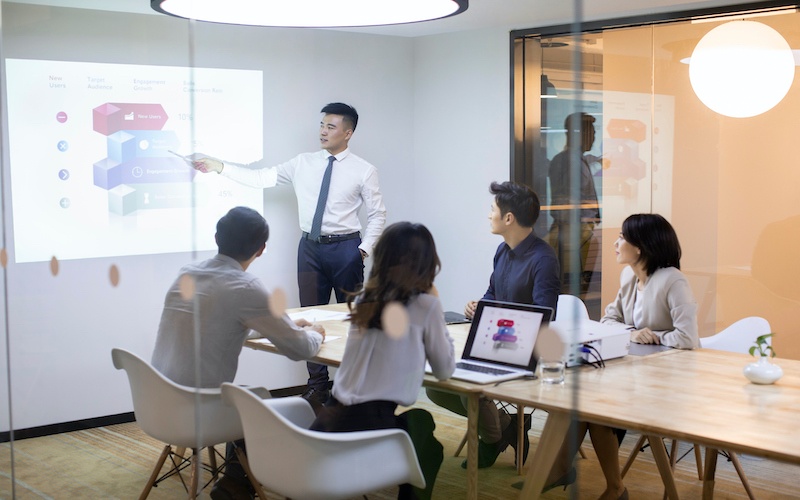 men presenting his work at a meeting