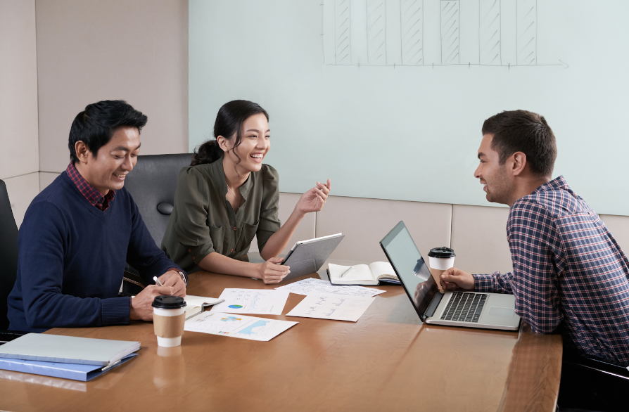 Side view of three people at a business meeting