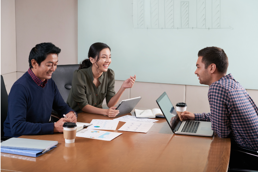 Side view of three people at a business meeting