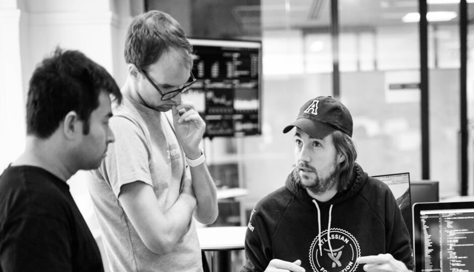 Photo by Aundray Cheam featuring Andrew Wakeling, Mike Cannon-Brookes & myself having a team alignment discussion back in the days at Atlassian. 