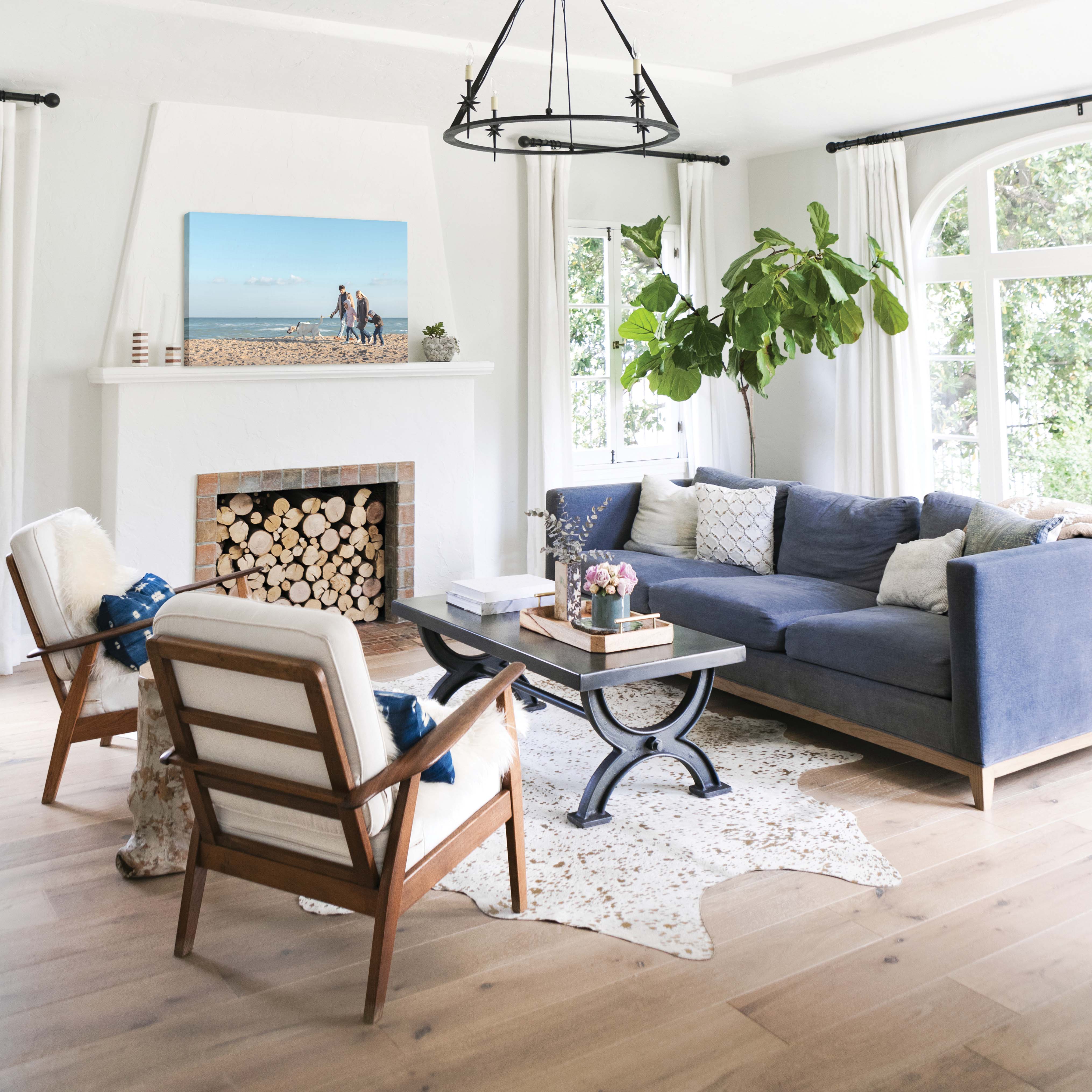 Canvas print of family walking along the beach above the fireplace