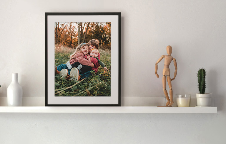 Framed print of siblings on a picture ledge