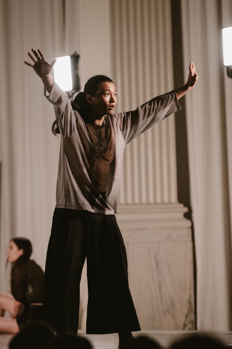 a male dancer holds his hands up outstretched toward the audience at a dance gala performance at Vibiana in Downtown Los Angeles