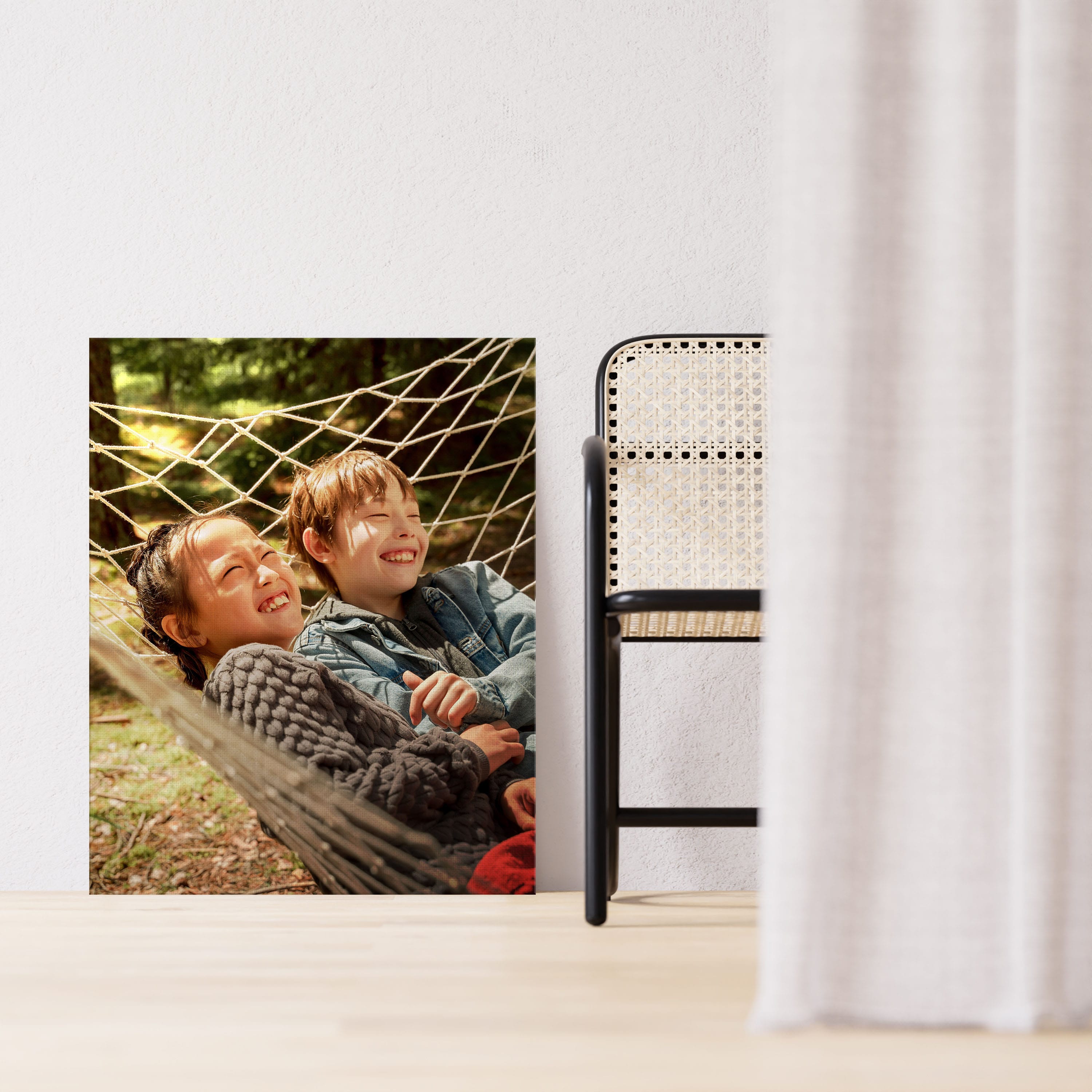Canvas print in living room of brother and sister in a hammock