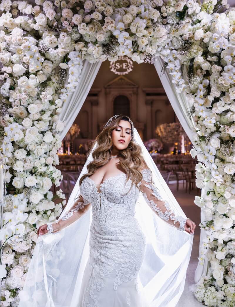 bride under flowers