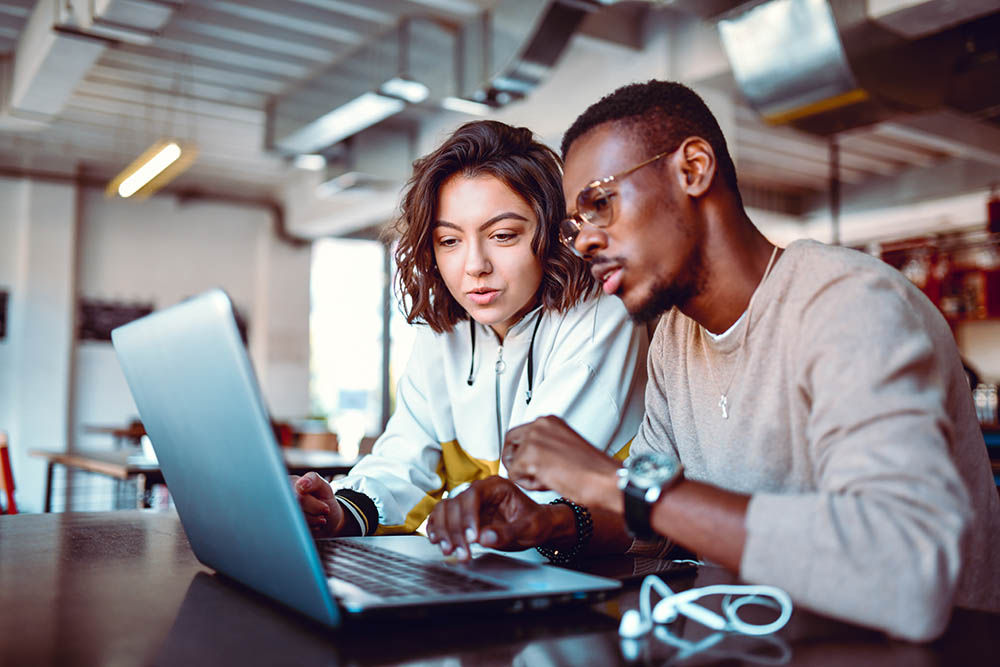 two-people-working-together-on-laptop.jpg