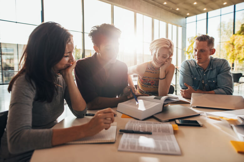 Photo of university students collaborating at a desk