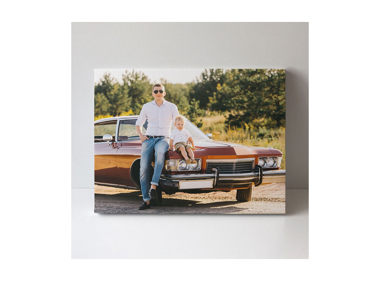 A canvas print showcasing a father and son posed with a classic car