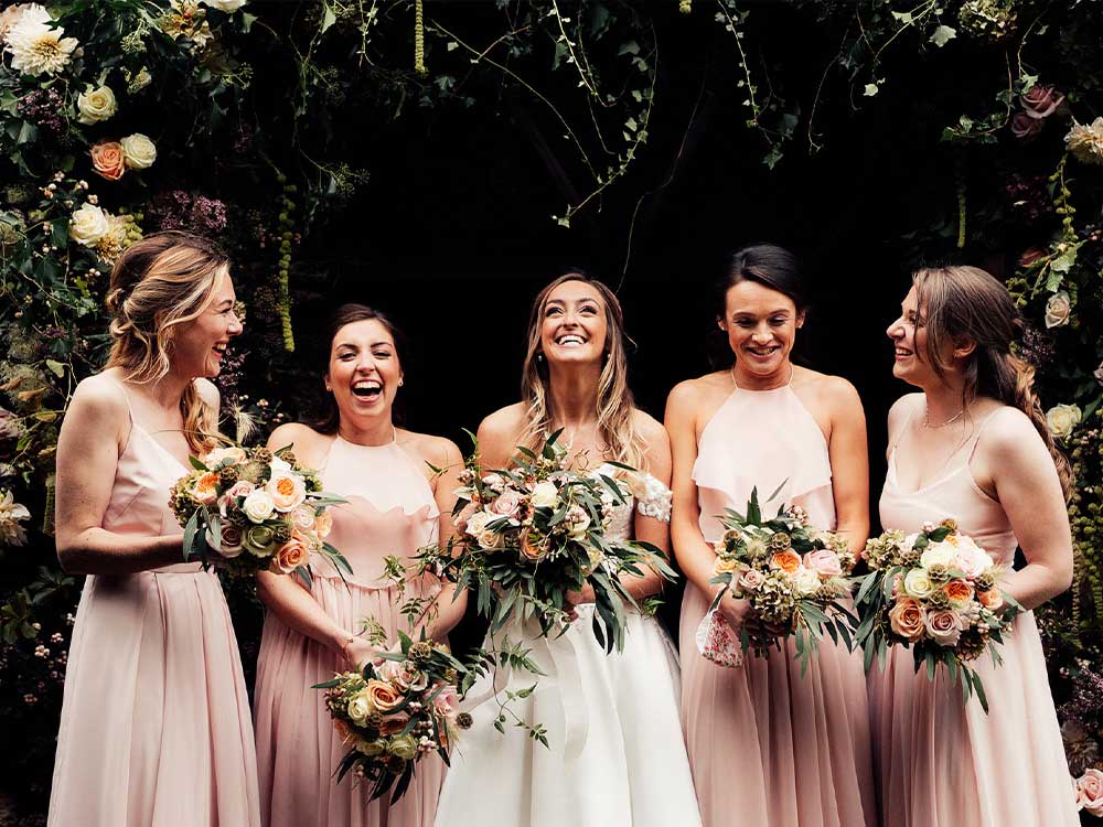 bride and bridesmaids with wedding flowers